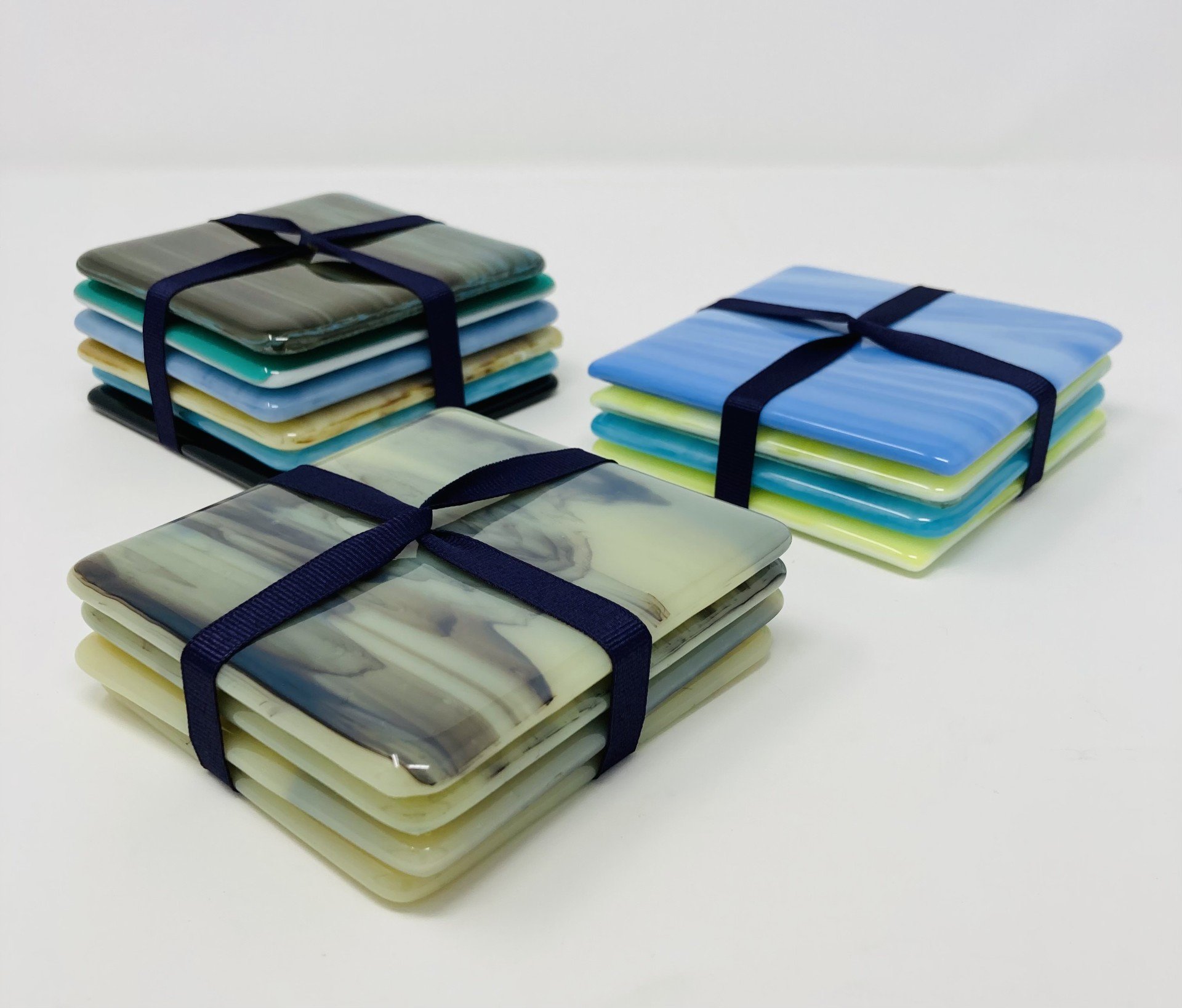 Fused glass coasters available as sets or for bulk orders. 15+ colors available. 4 inch square. Price varies by color and quantity.