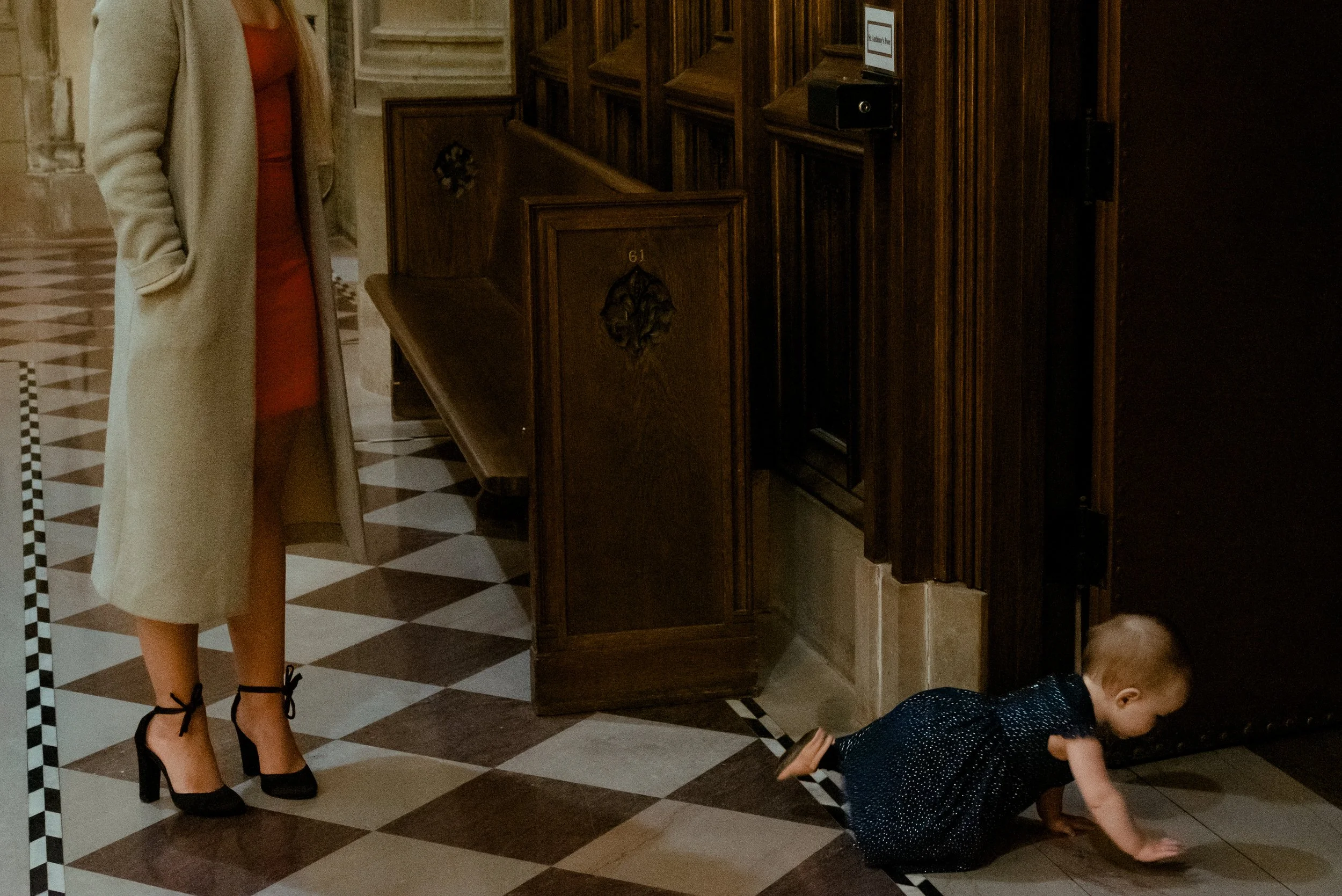 Baby crawls on Montreal Church during wedding ceremony as mother watches on.