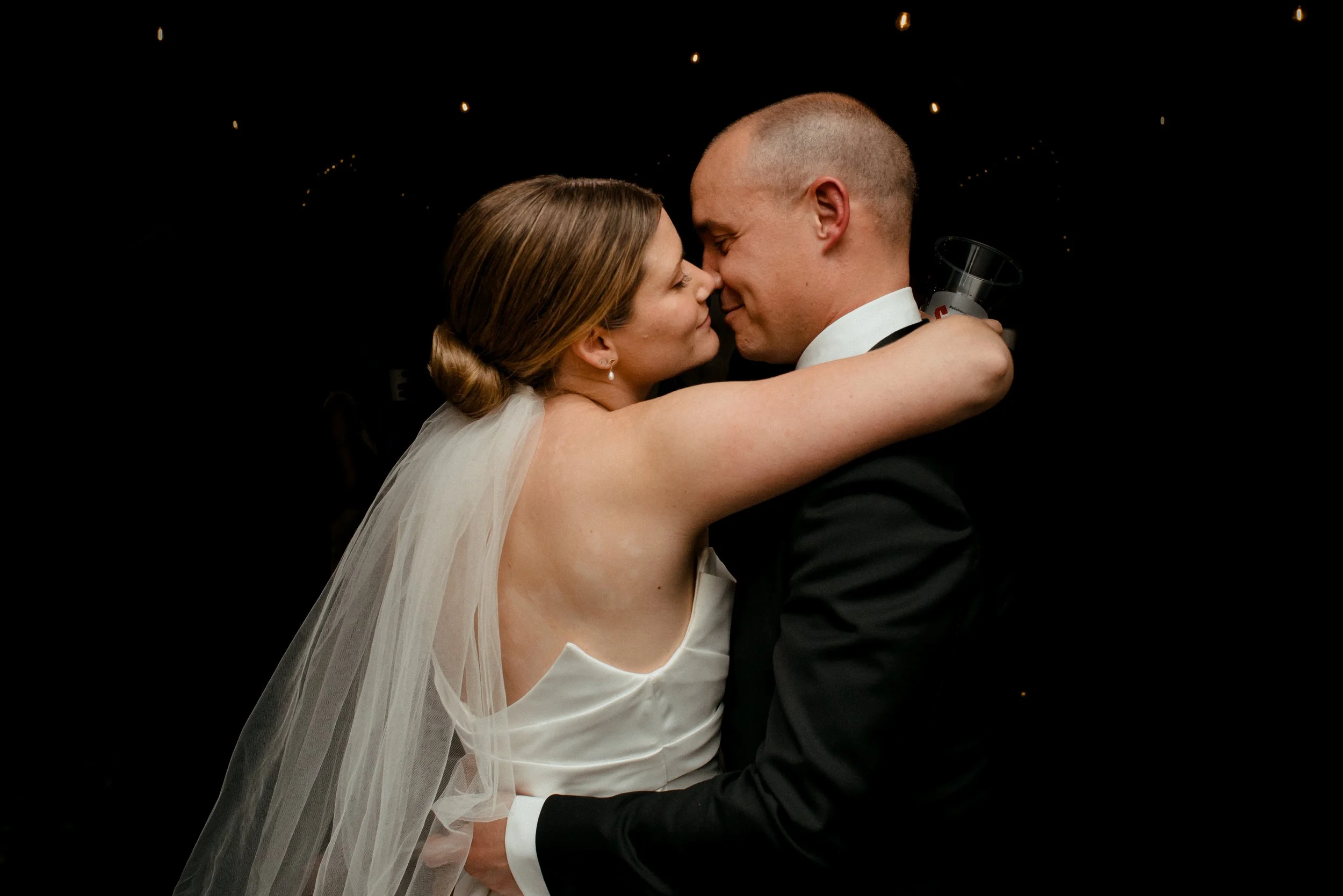 Closeup of couple embracing as the background fades to black