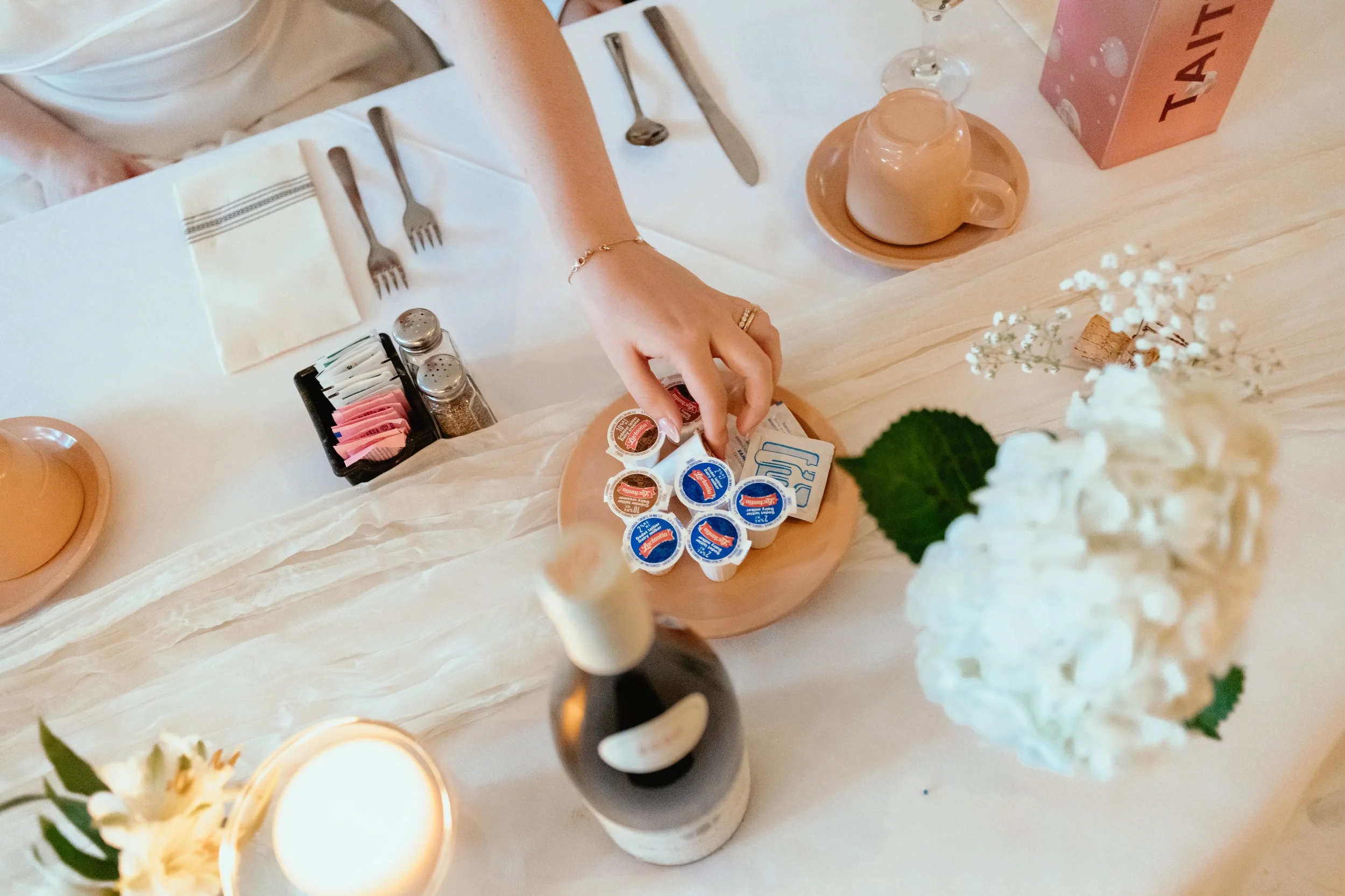 Detail image of bride reaching for coffee milker at this Montreal wedding reception