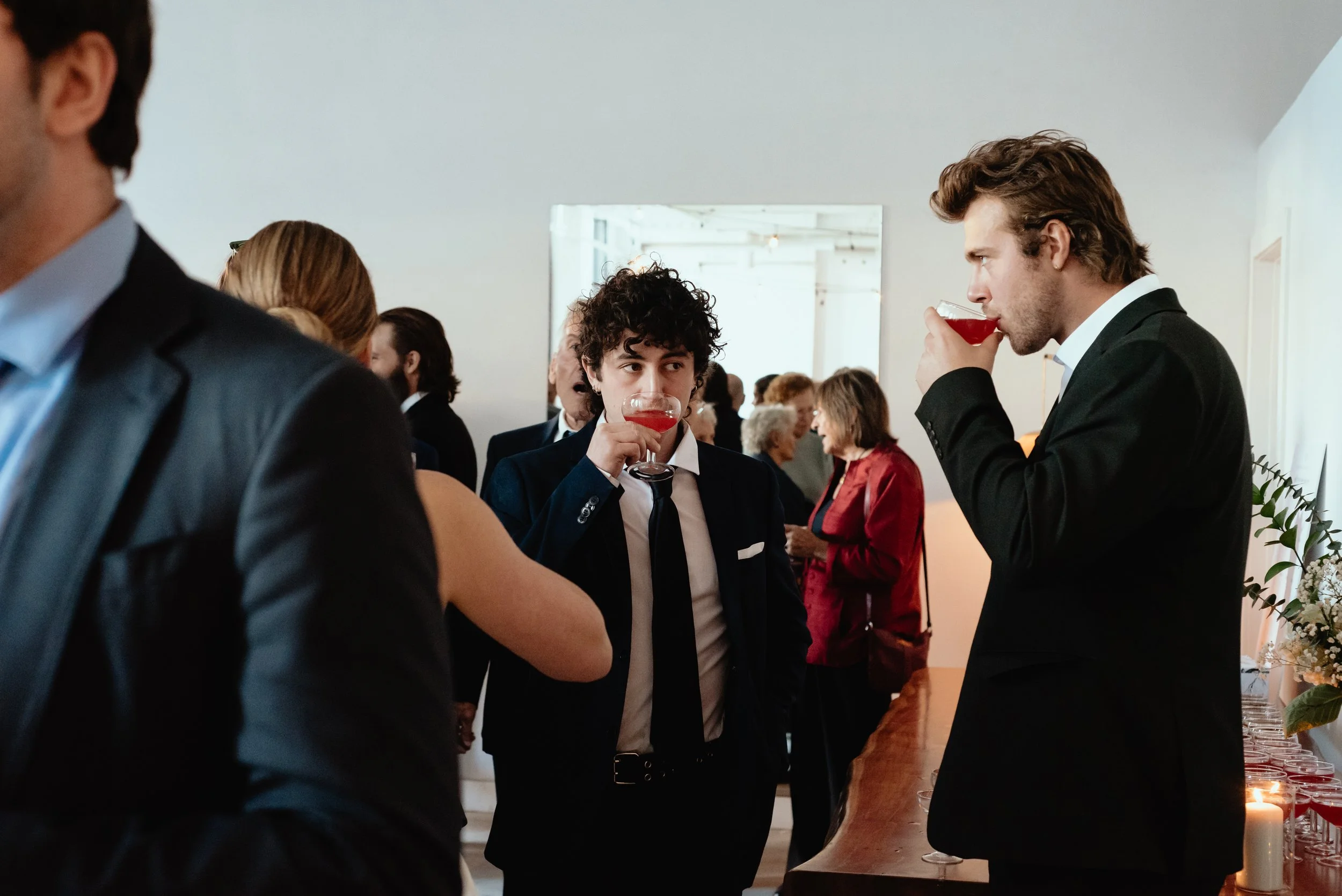 Wedding guests holding cocktails and socializing at an indoor Montreal wedding reception.