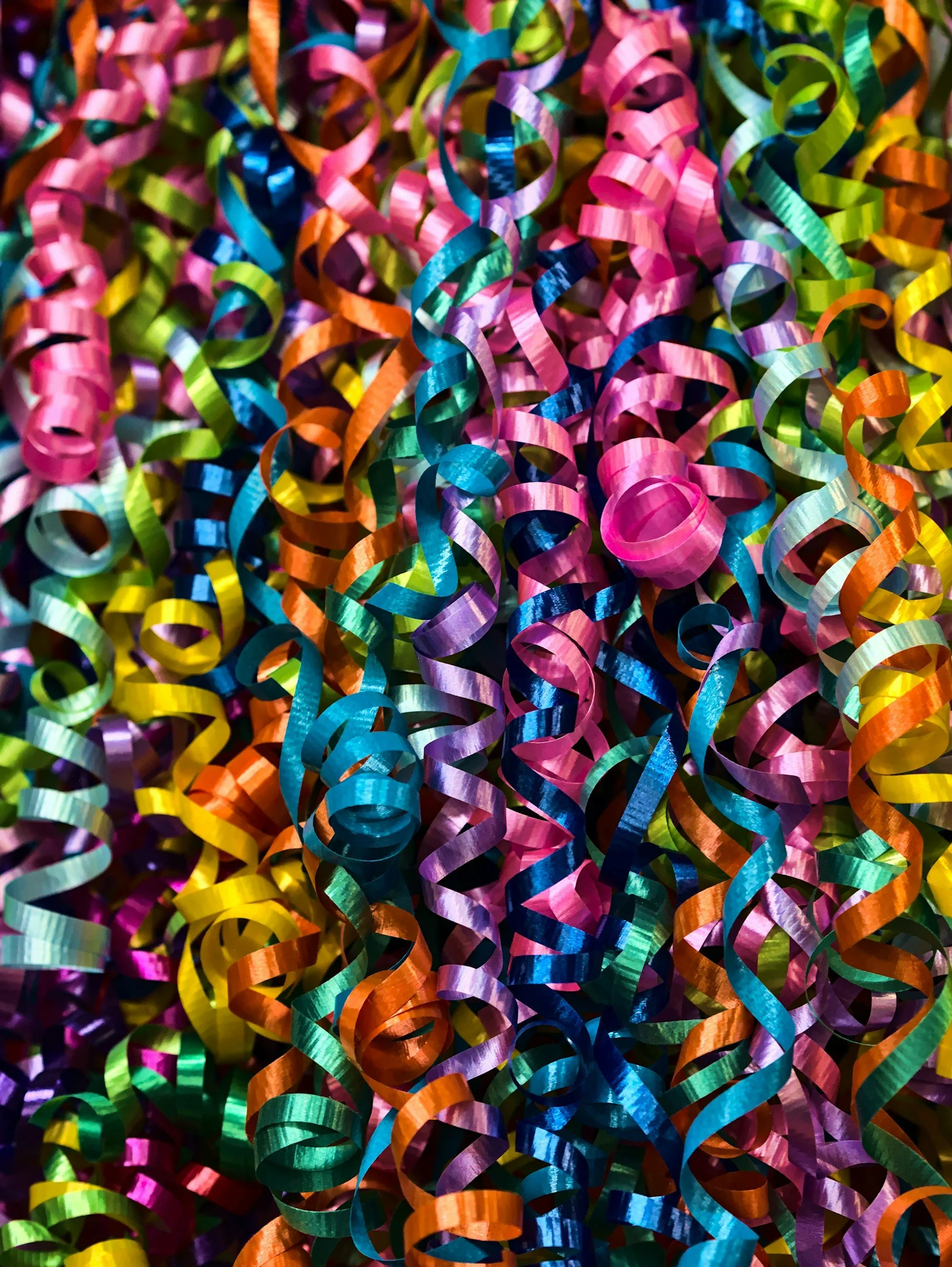 Close up of multi-coloured, curly party streamers