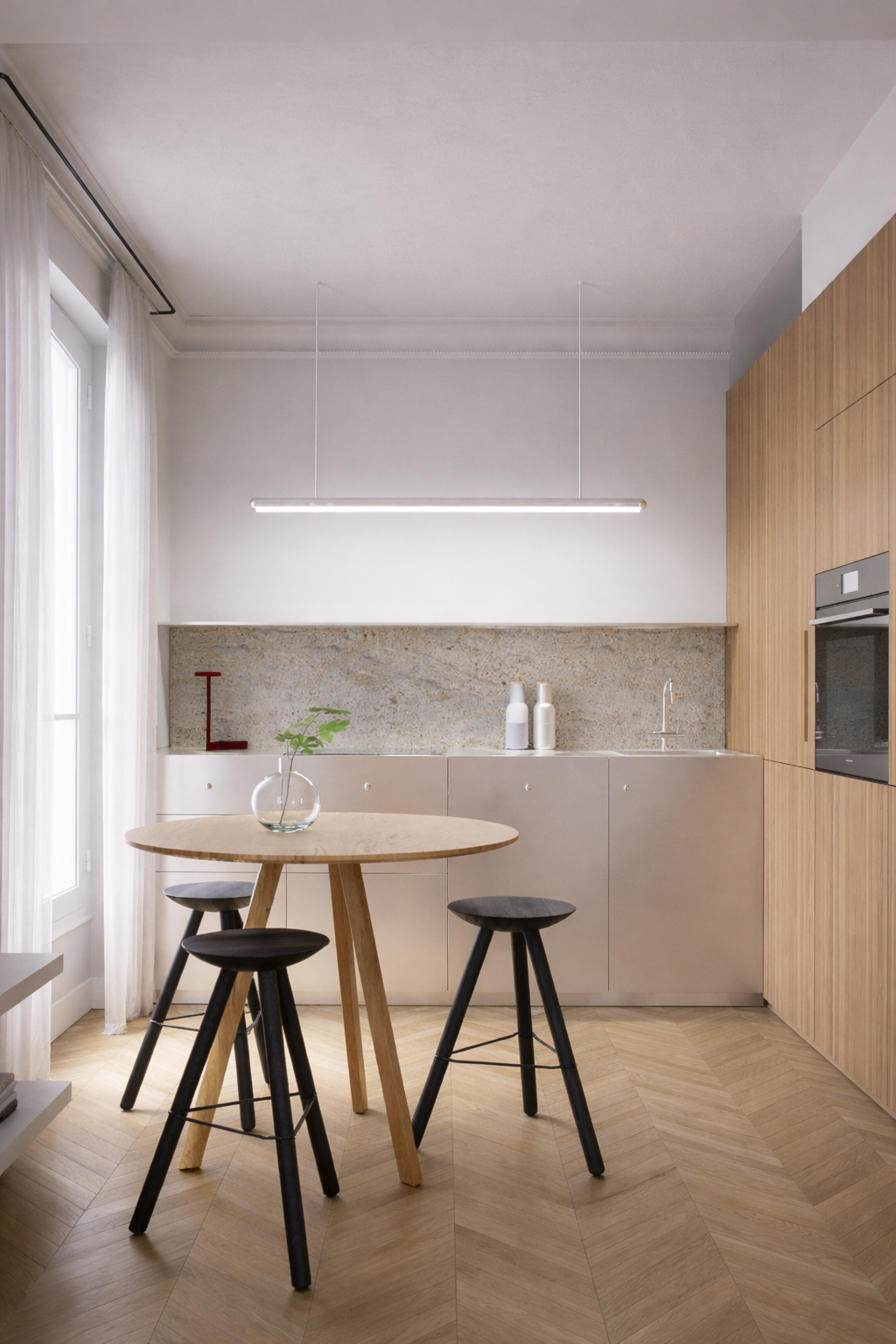 Modern kitchen with wooden and beige cabinetry, granite backsplash, round wooden table with black stools, and large windows with white curtains.