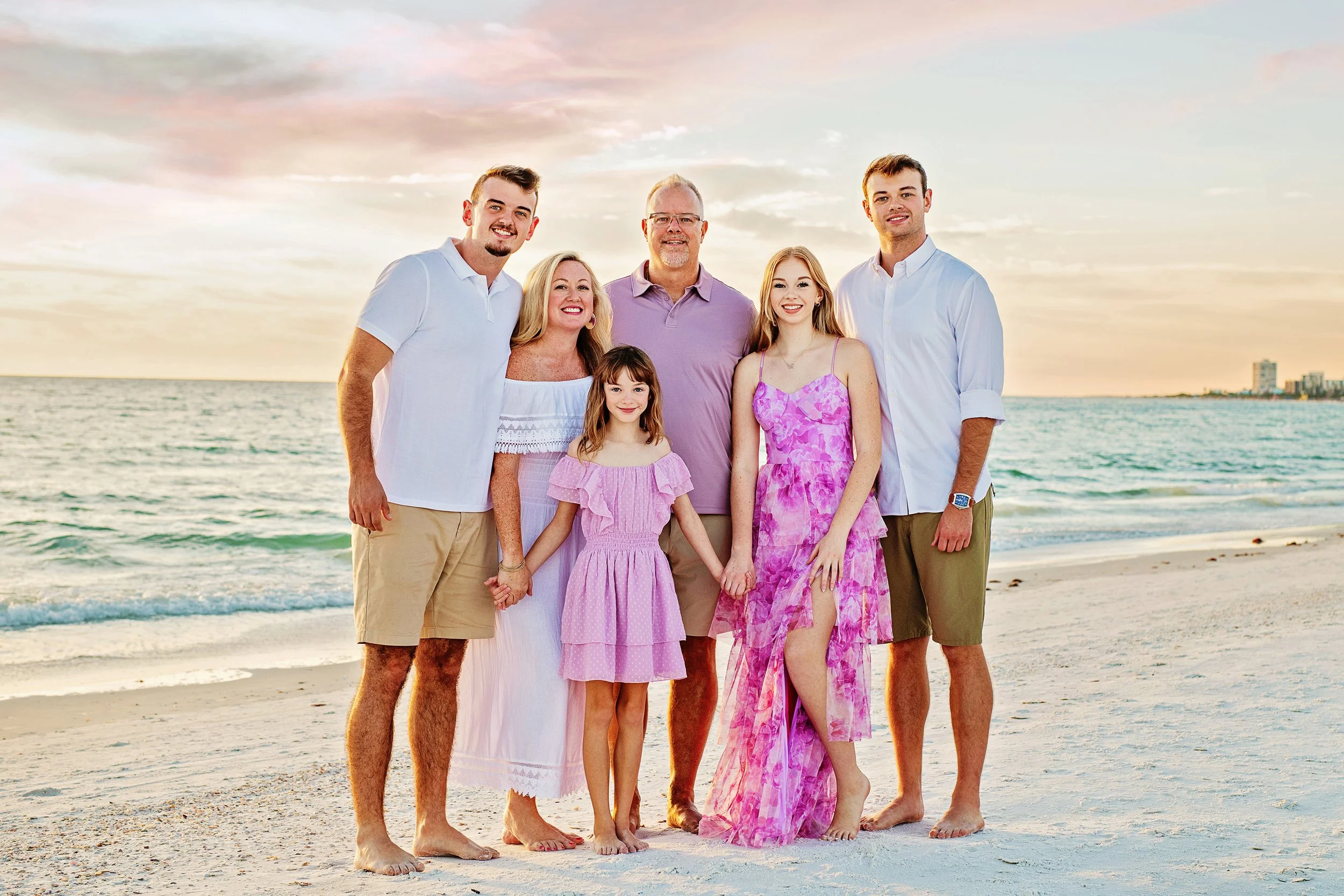 Family of 6 posing for family photos on Siesta Key beach, beautiful sunset