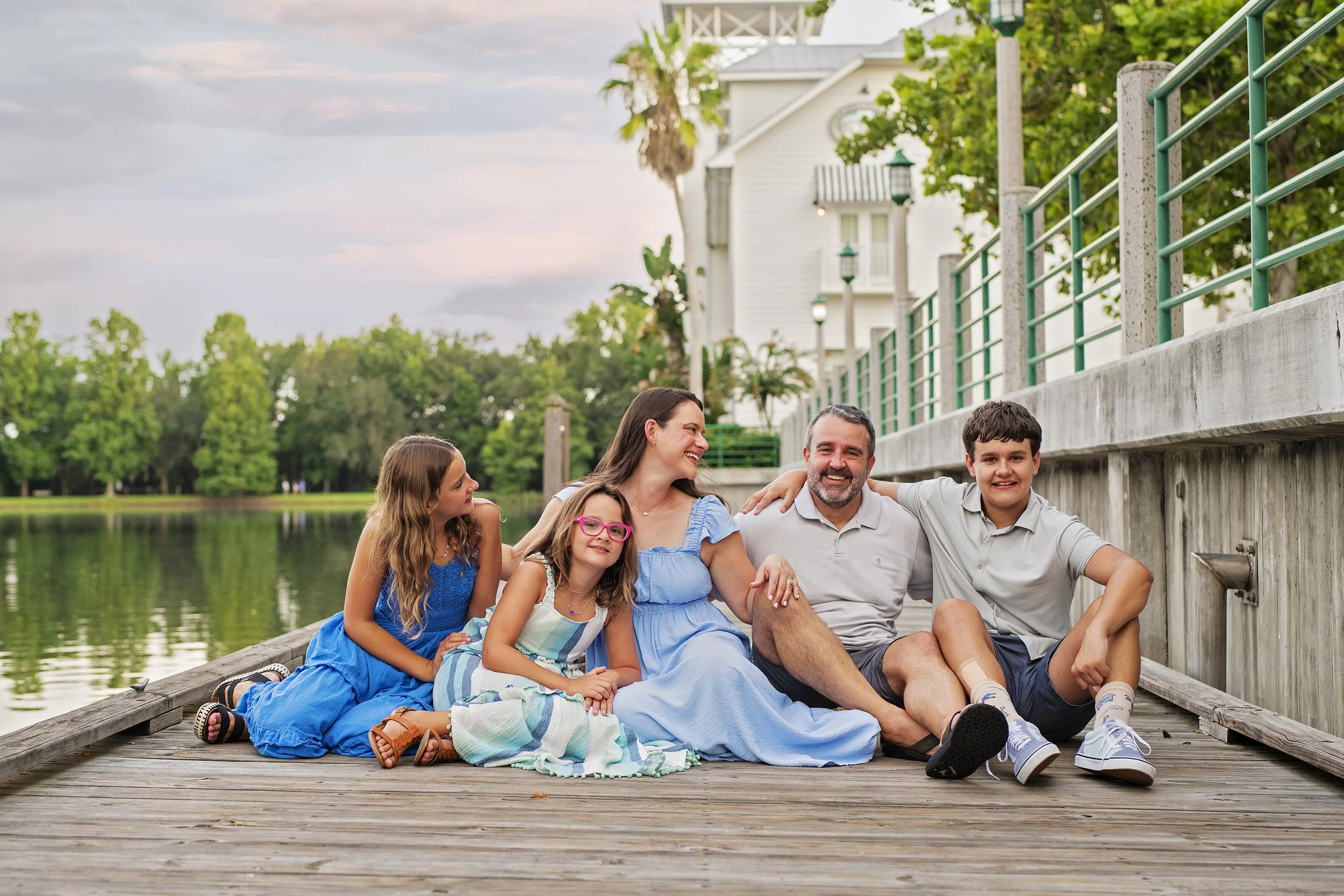 Family of 5 on vacation in Kissimmee Florida at Downtown Celebration on a dock at sunset