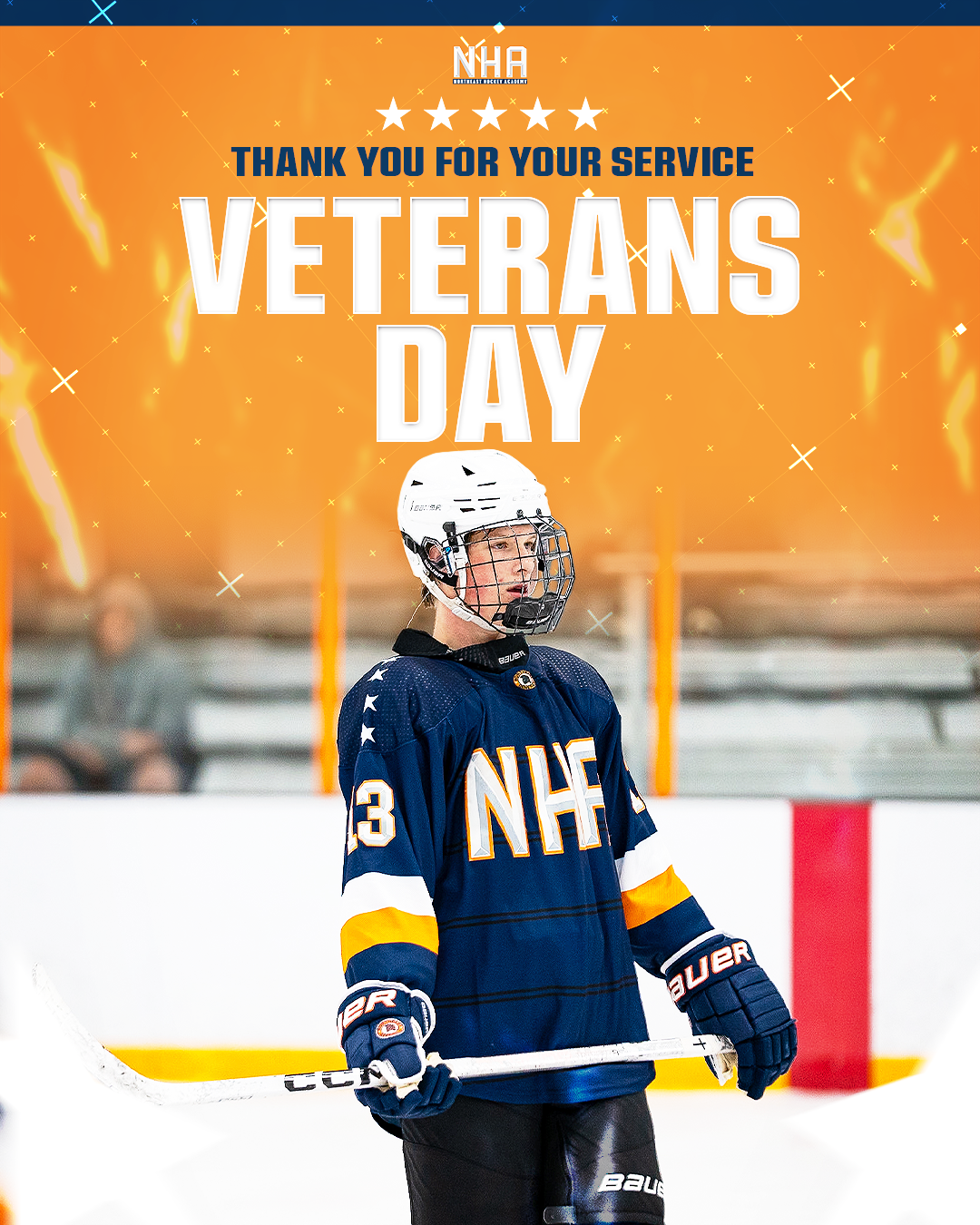A young hockey player in a blue and yellow jersey with the number 23, holding a hockey stick, stands on an ice rink, with a bright orange background and text celebrating Veterans Day.