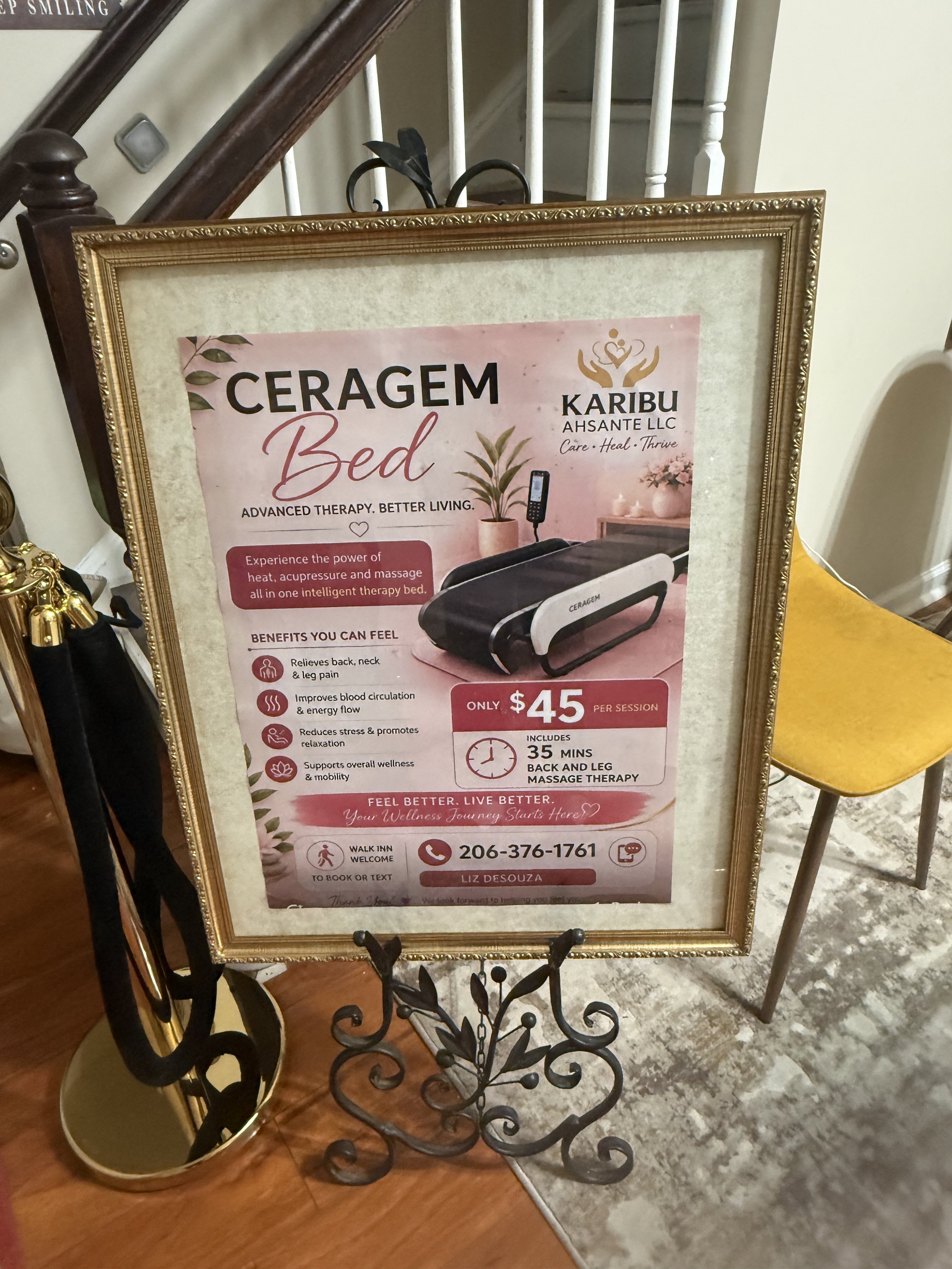A framed flyer on an easel advertising Ceragem bed therapy, featuring a massage device and promoting health benefits such as pain relief, improved circulation, and relaxation, with contact information and pricing details.