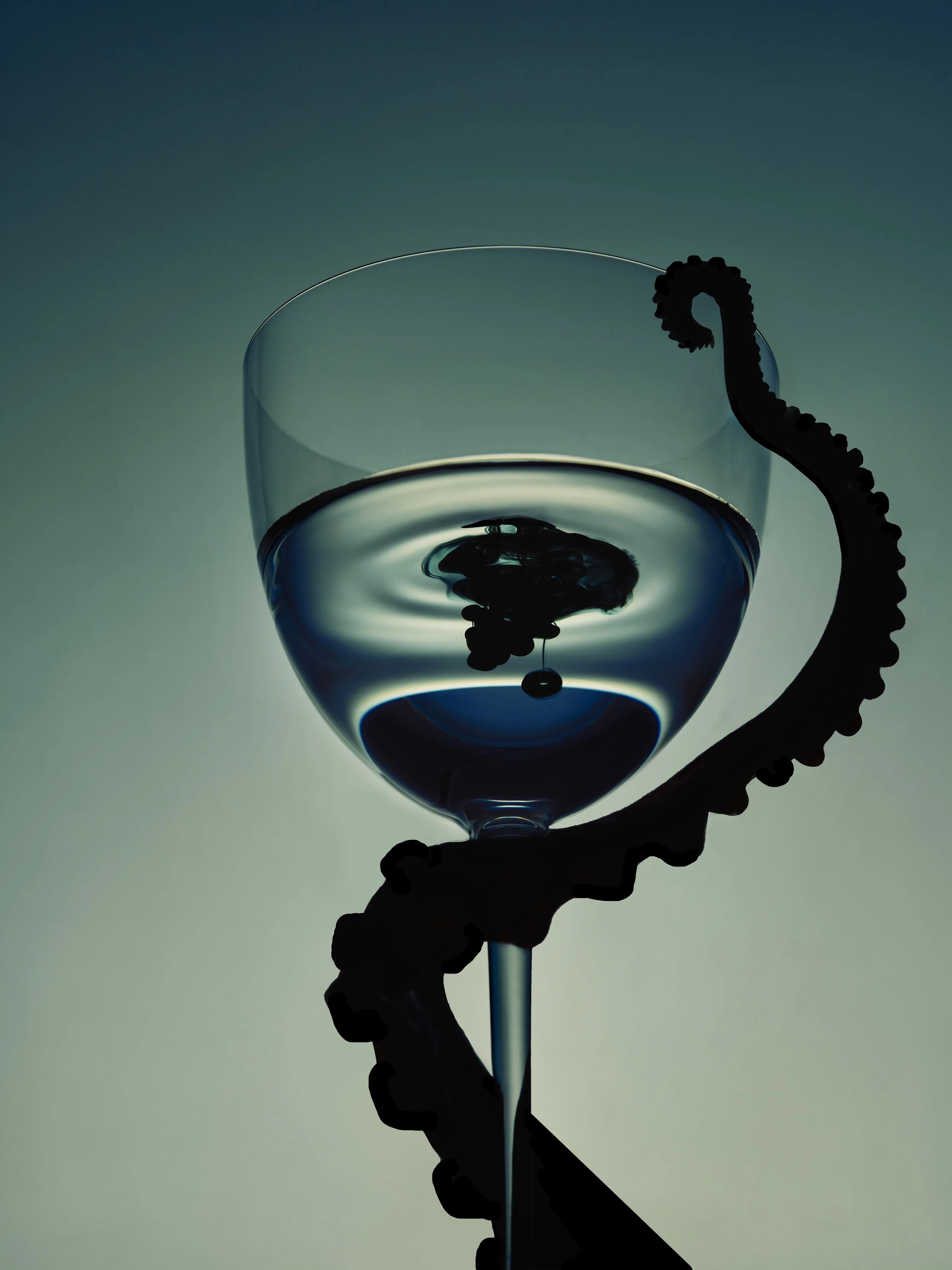 Silhouette of a hand holding a wine glass filled with water, with a tentacle resting on the rim of the glass, in front of a gradient blue-green background.