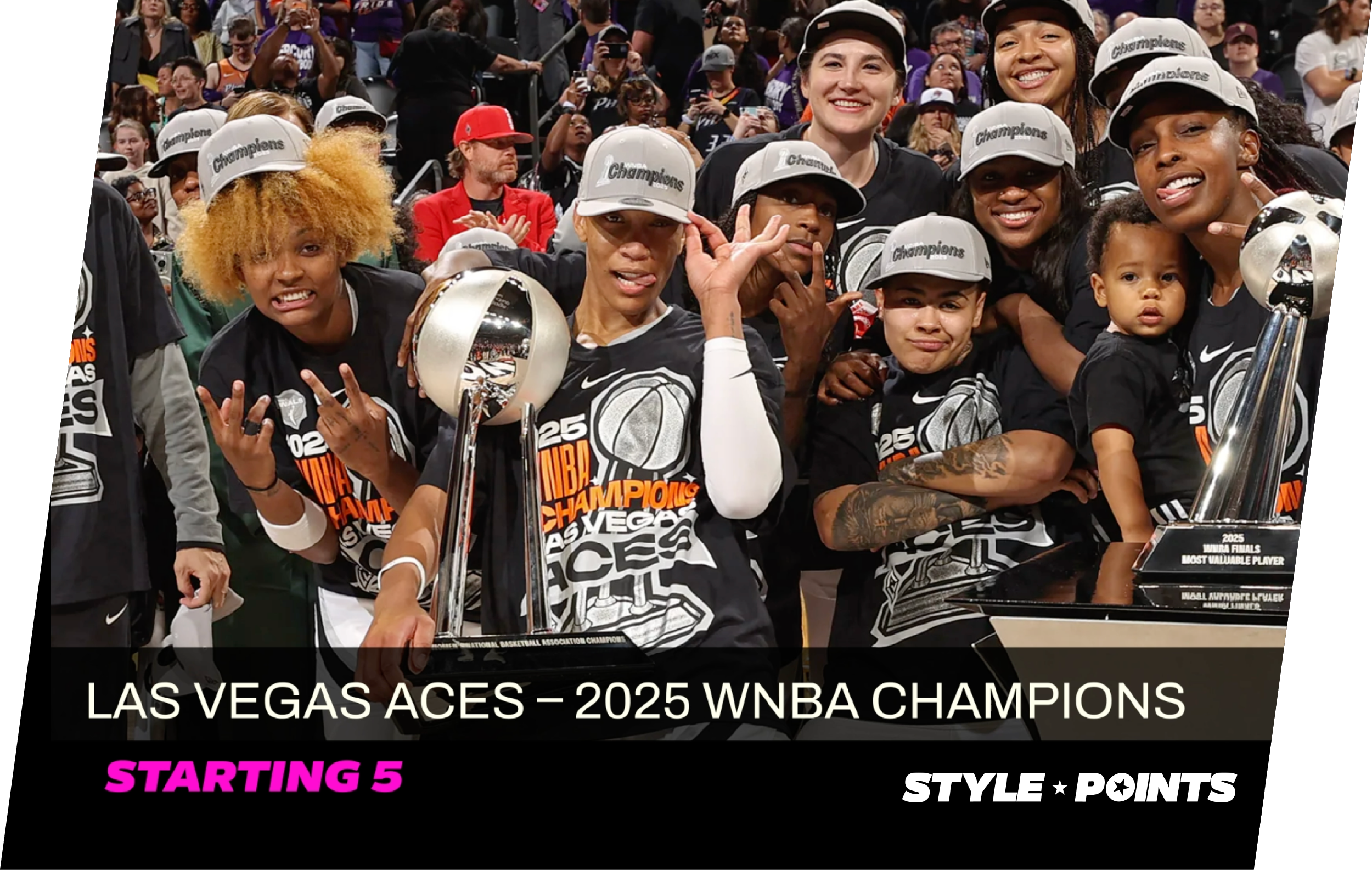 A group of women celebrating with championship trophies at the 2025 WNBA Finals in Las Vegas. They are wearing matching shirts and caps with 'Champions' and 'Las Vegas Aces' written on them, smiling, and posing for the photo.