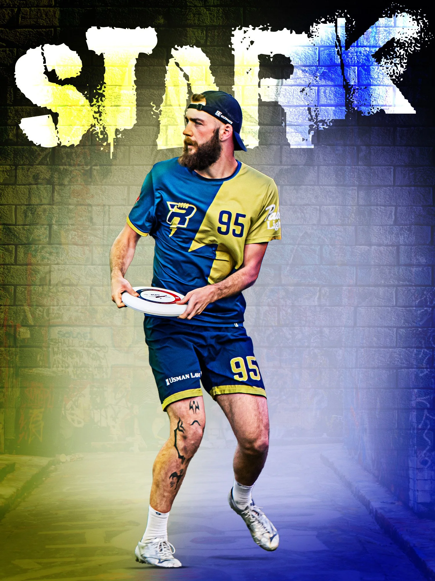 A man with a beard wearing a black cap backwards, a blue and yellow sports jersey with the number 95, and athletic shorts, holding a frisbee, standing in front of a brick wall with graffiti-style art of a thumbs-up and a speech bubble.