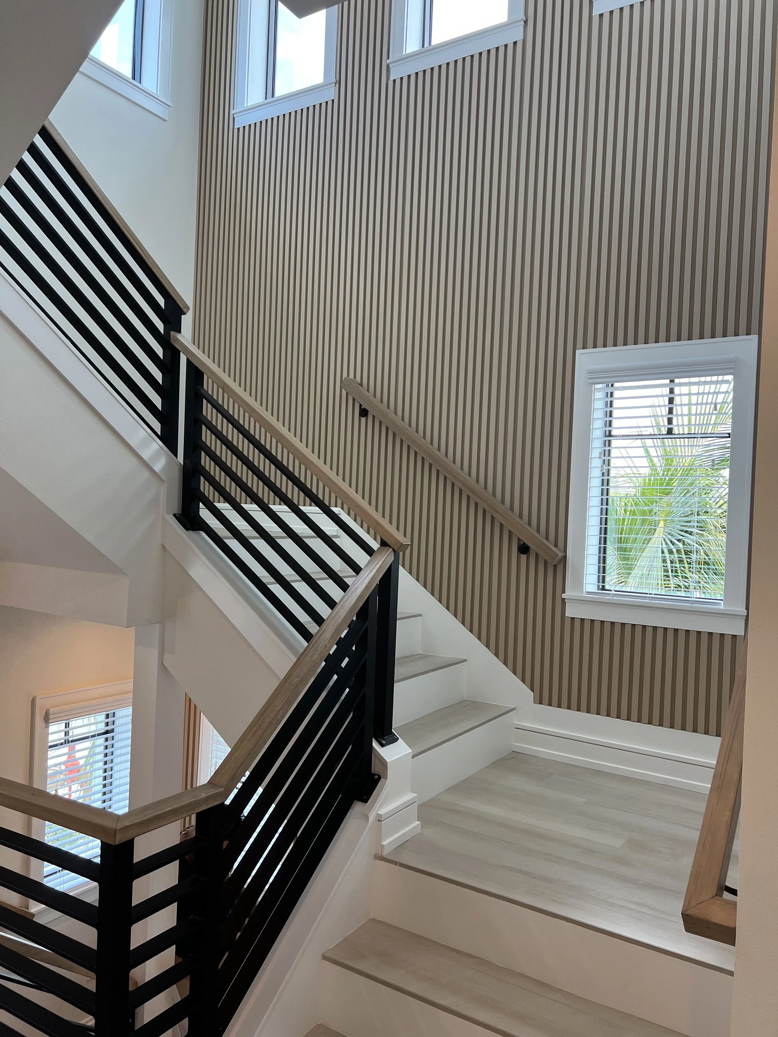 Stairwell with vertical wood slats and wood handrails — Project 07.