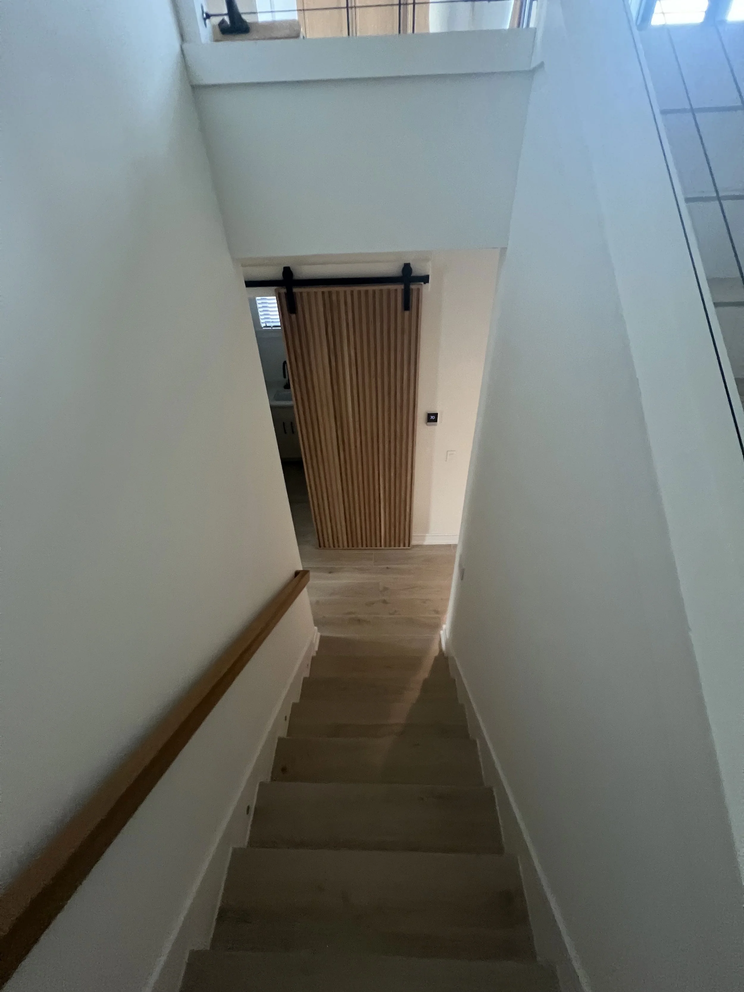 Staircase with wood handrail and sliding door — Project 02.