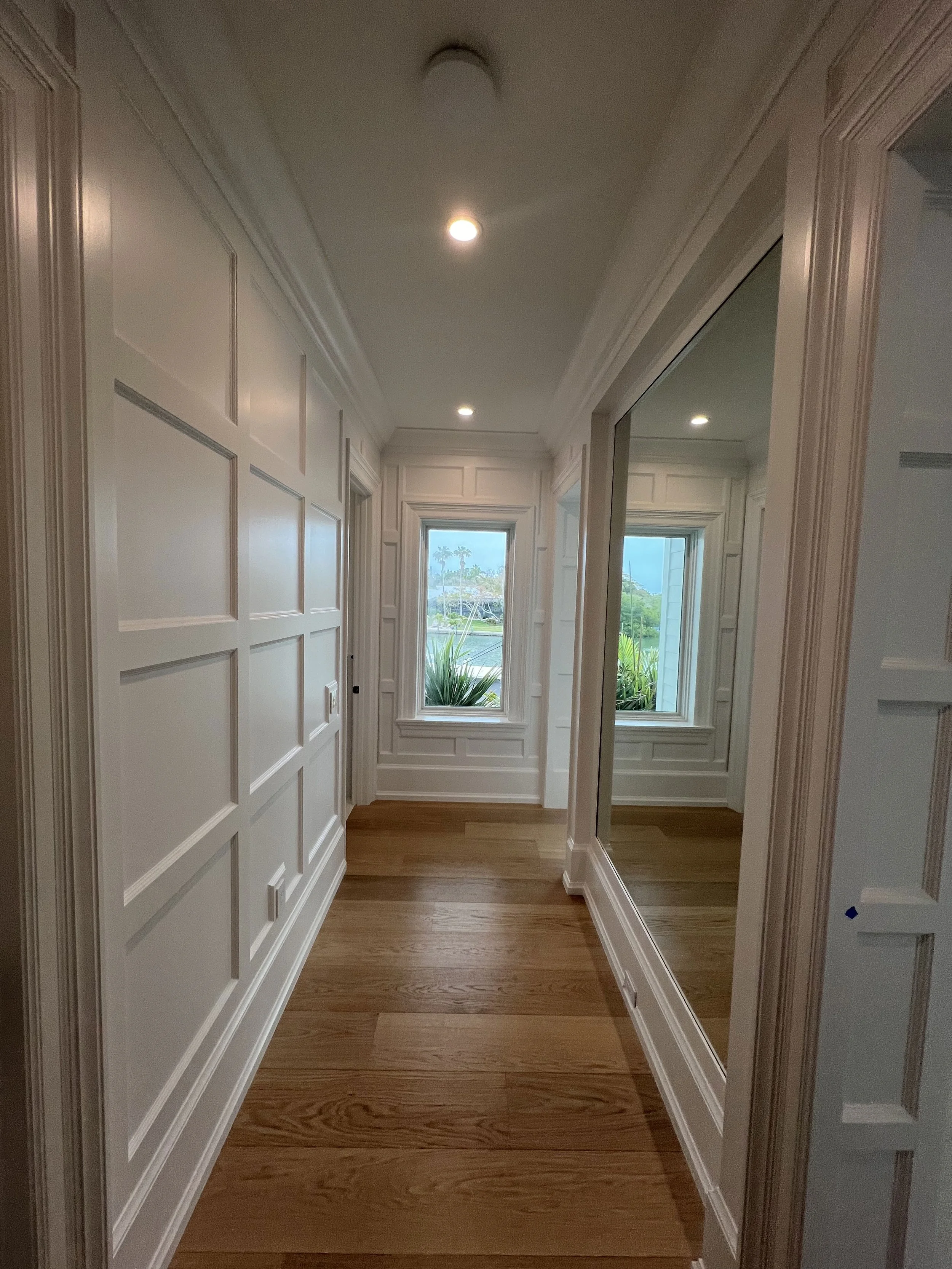 Hallway with decorative wall paneling and door casings — Project 06.