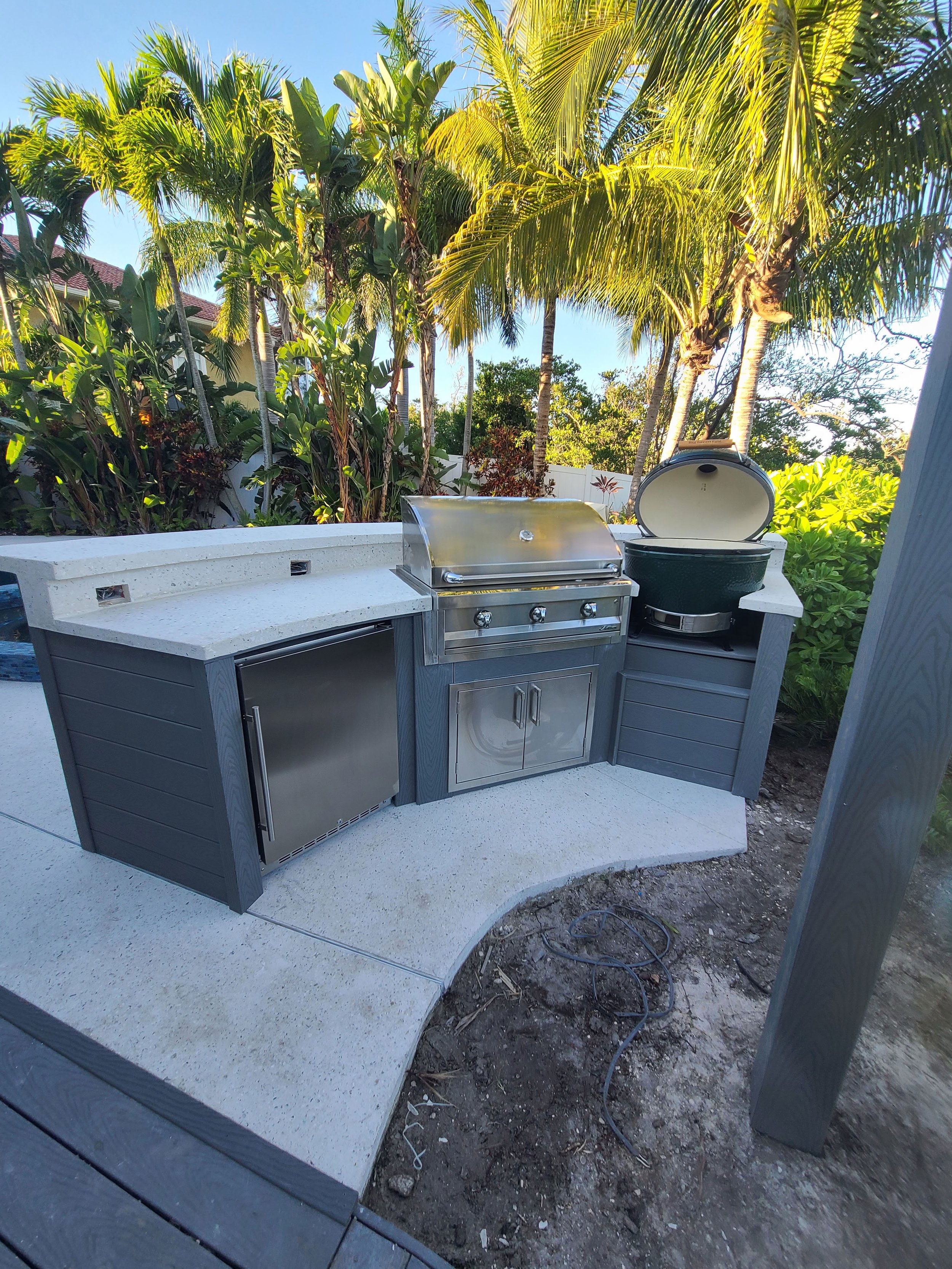 Outdoor kitchen with built-in grill and gray cabinetry — Project 03.