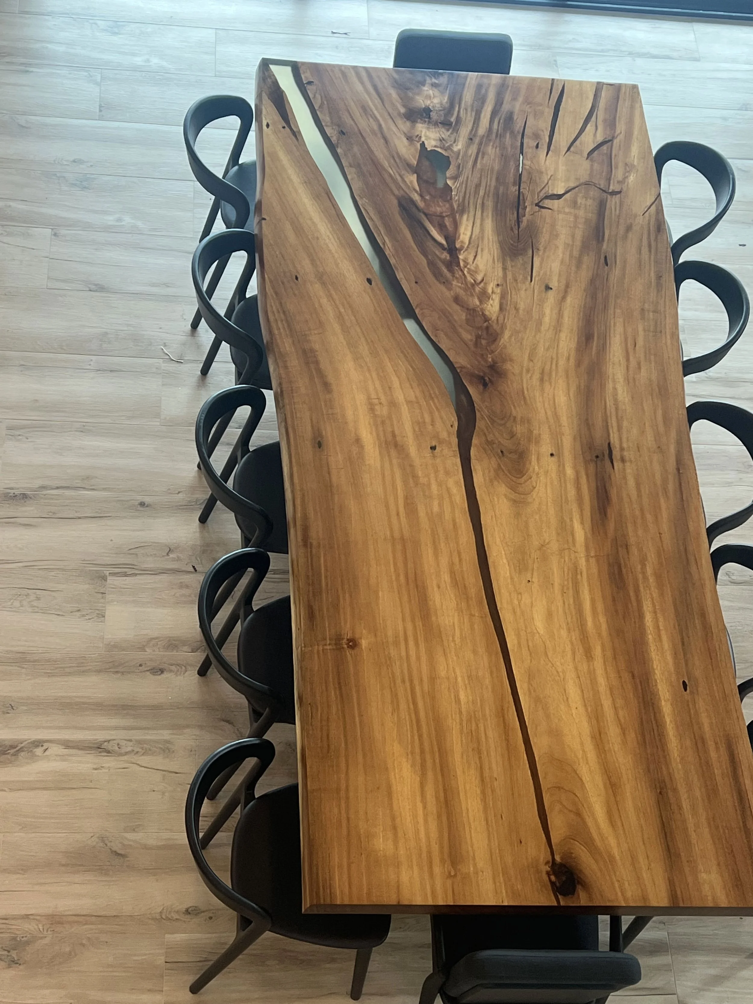 Overhead view of the dining table showing the wood grain and dark natural seams — Project 04.