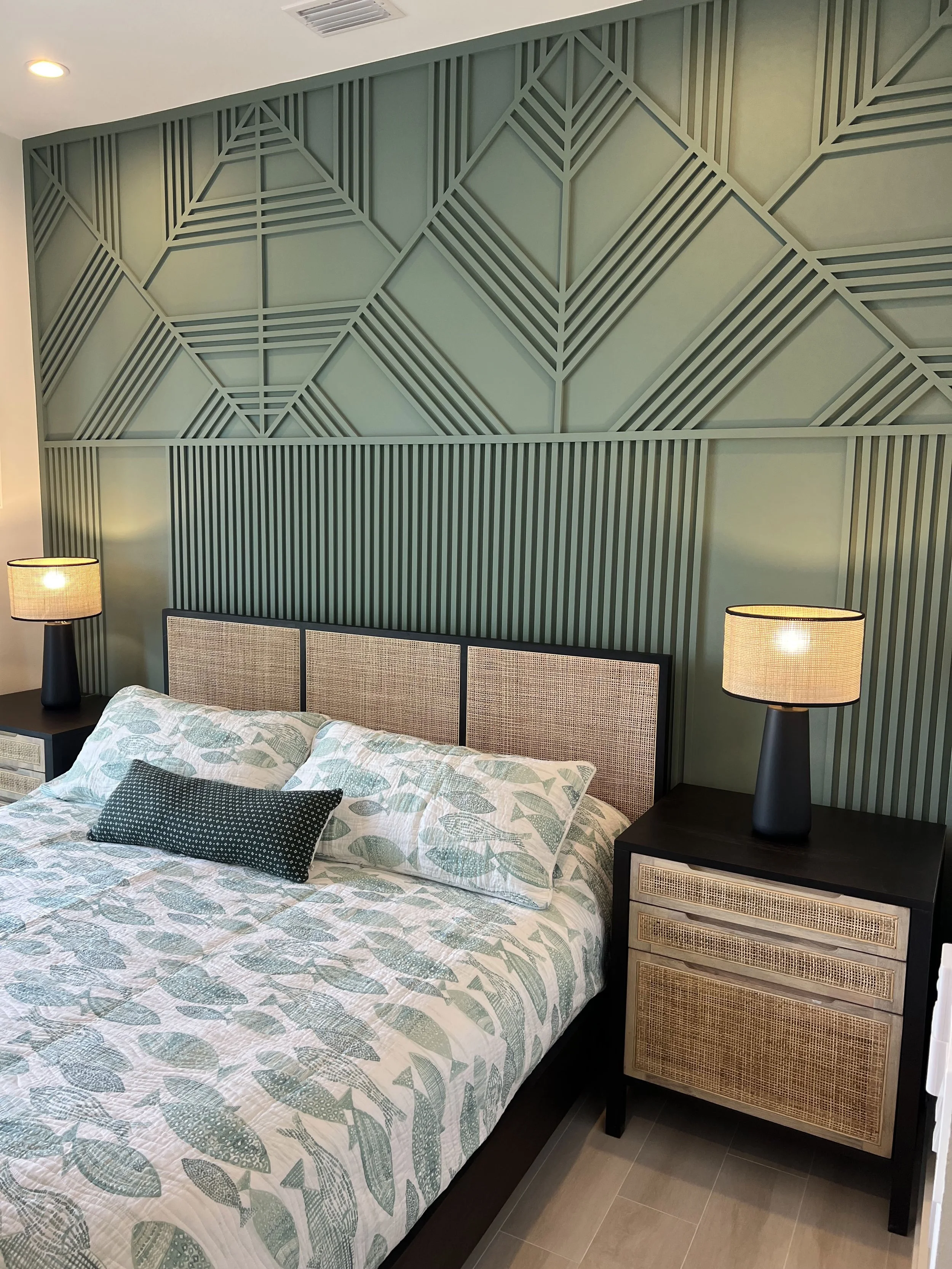Green geometric wood accent wall behind the bed — Project 07.
