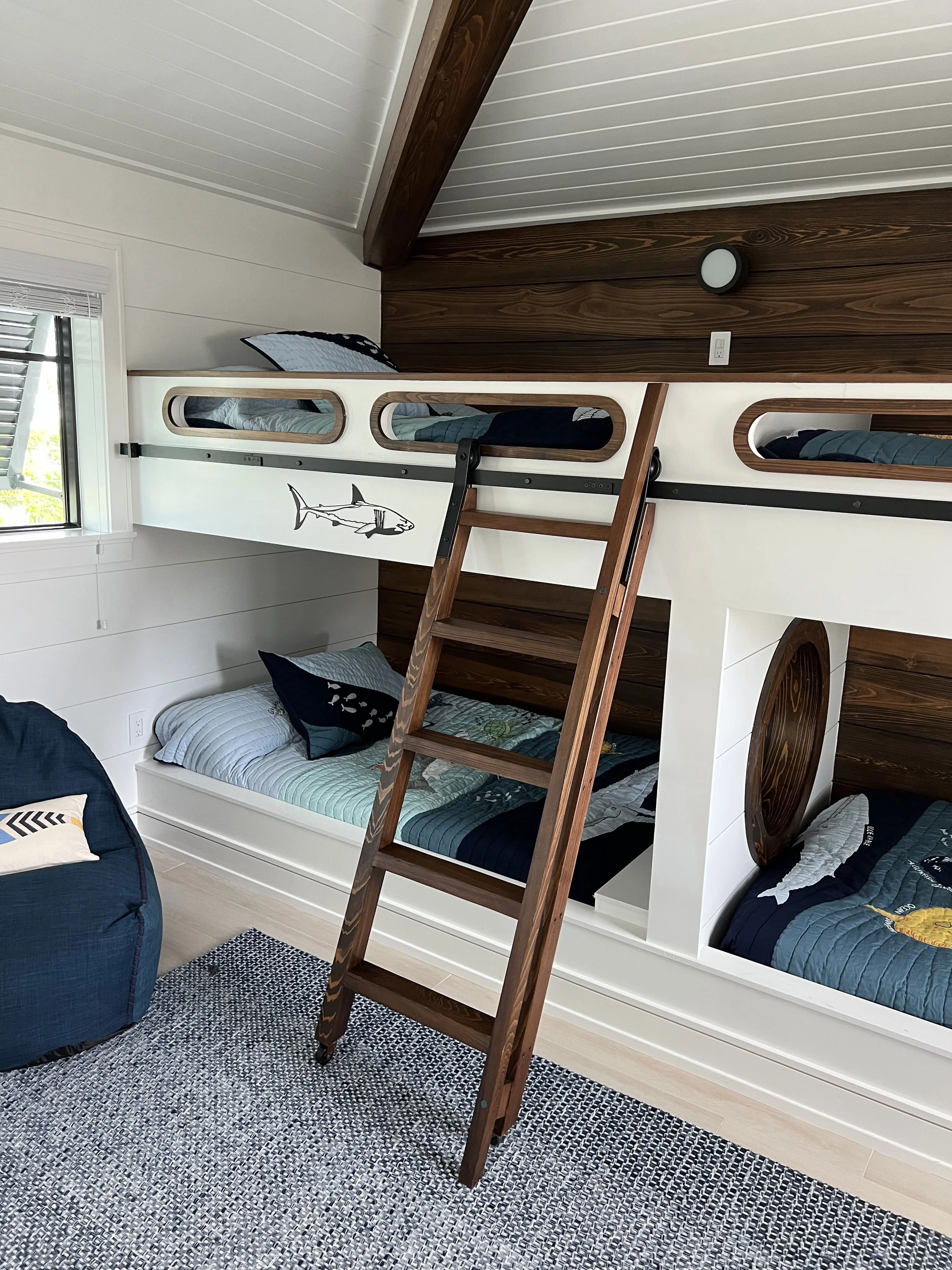Custom nautical bunk beds with wood ladders and ceiling beams — Project 07.