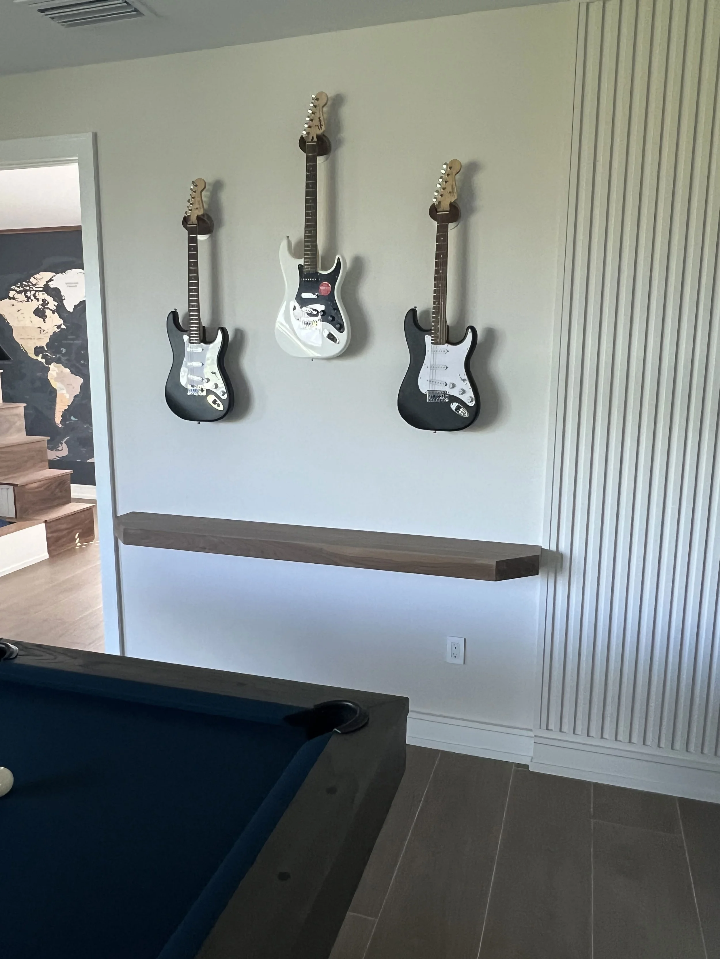 Vertical wood slat feature wall with guitar display — Project 08.