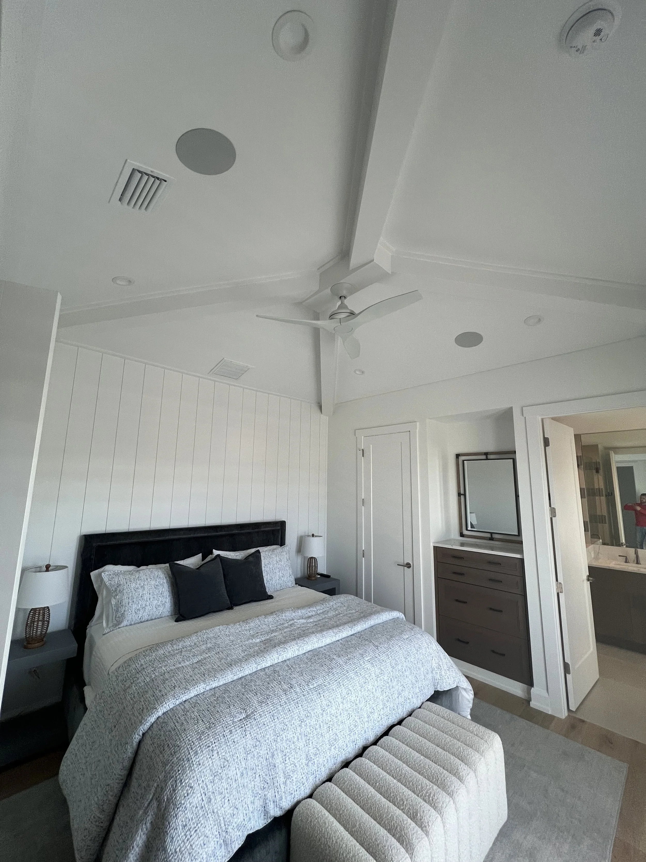 Vaulted bedroom ceiling with exposed beams and paneled walls — Project 05.
