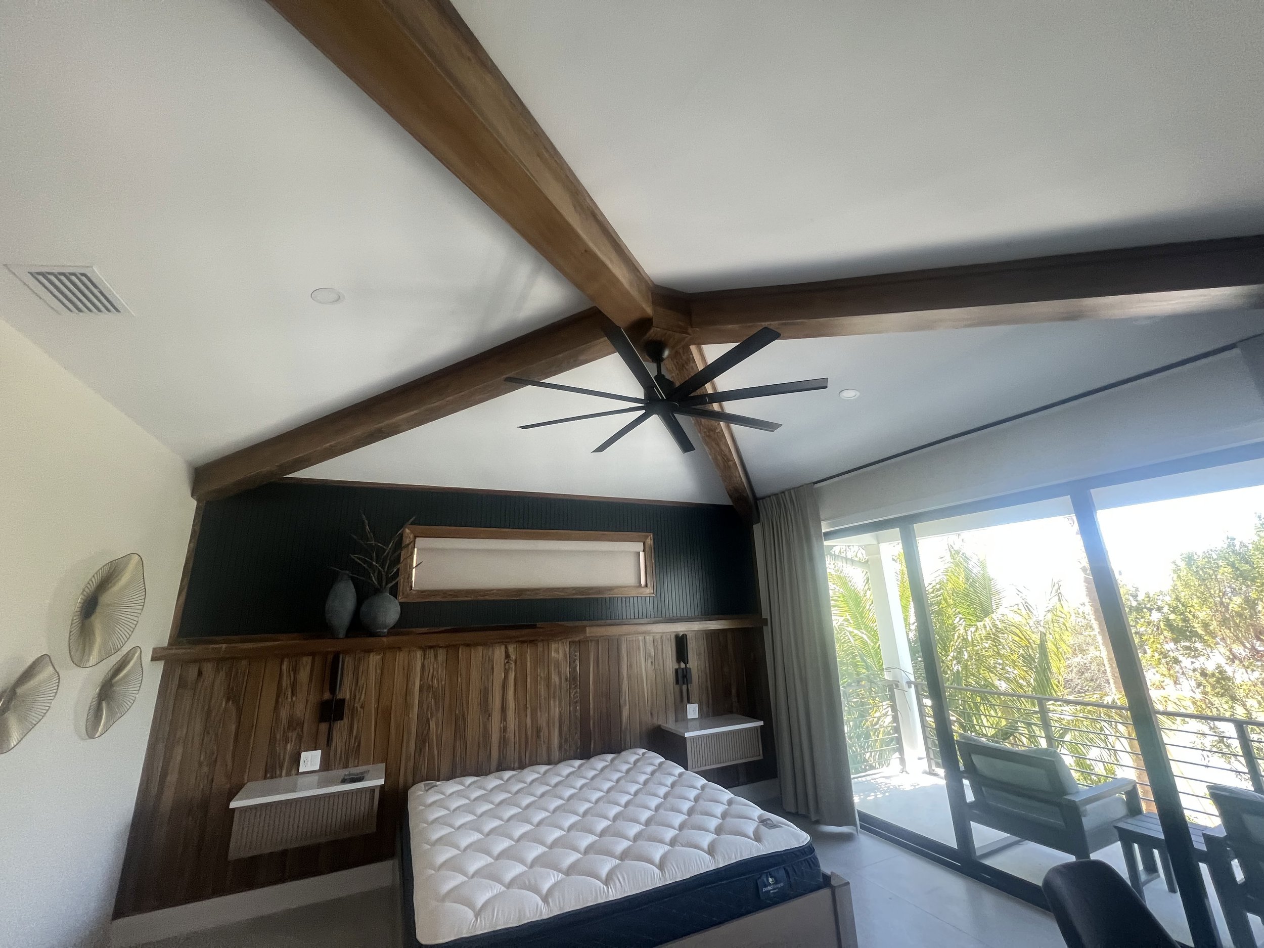 Bedroom with exposed beams and wood feature wall — Project 01.