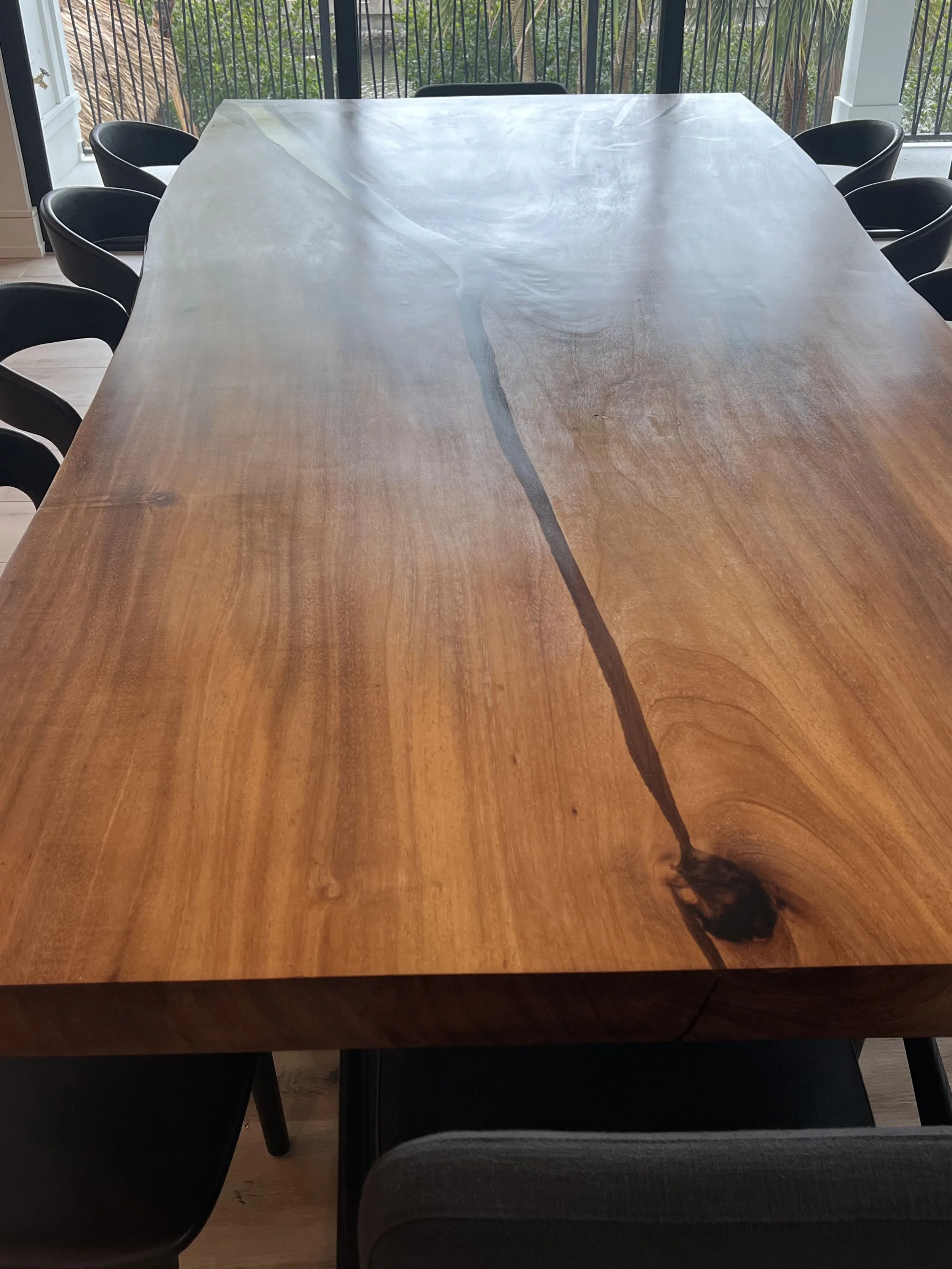 Close view along the dining tabletop showing the finish and grain — Project 04.