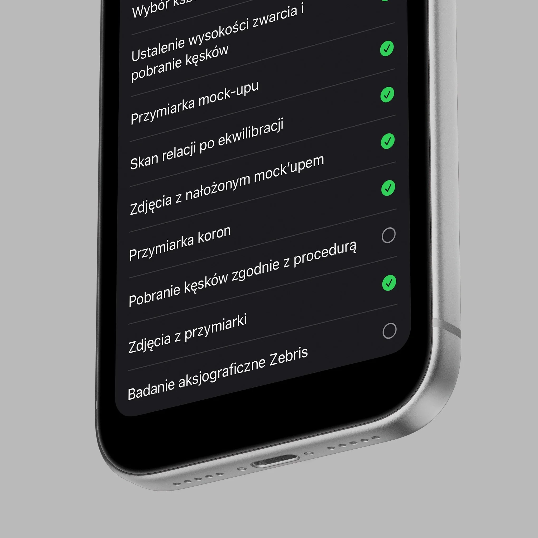 Close-up of a smartphone screen showing a checklist in Polish, with several items checked off and a gray background.