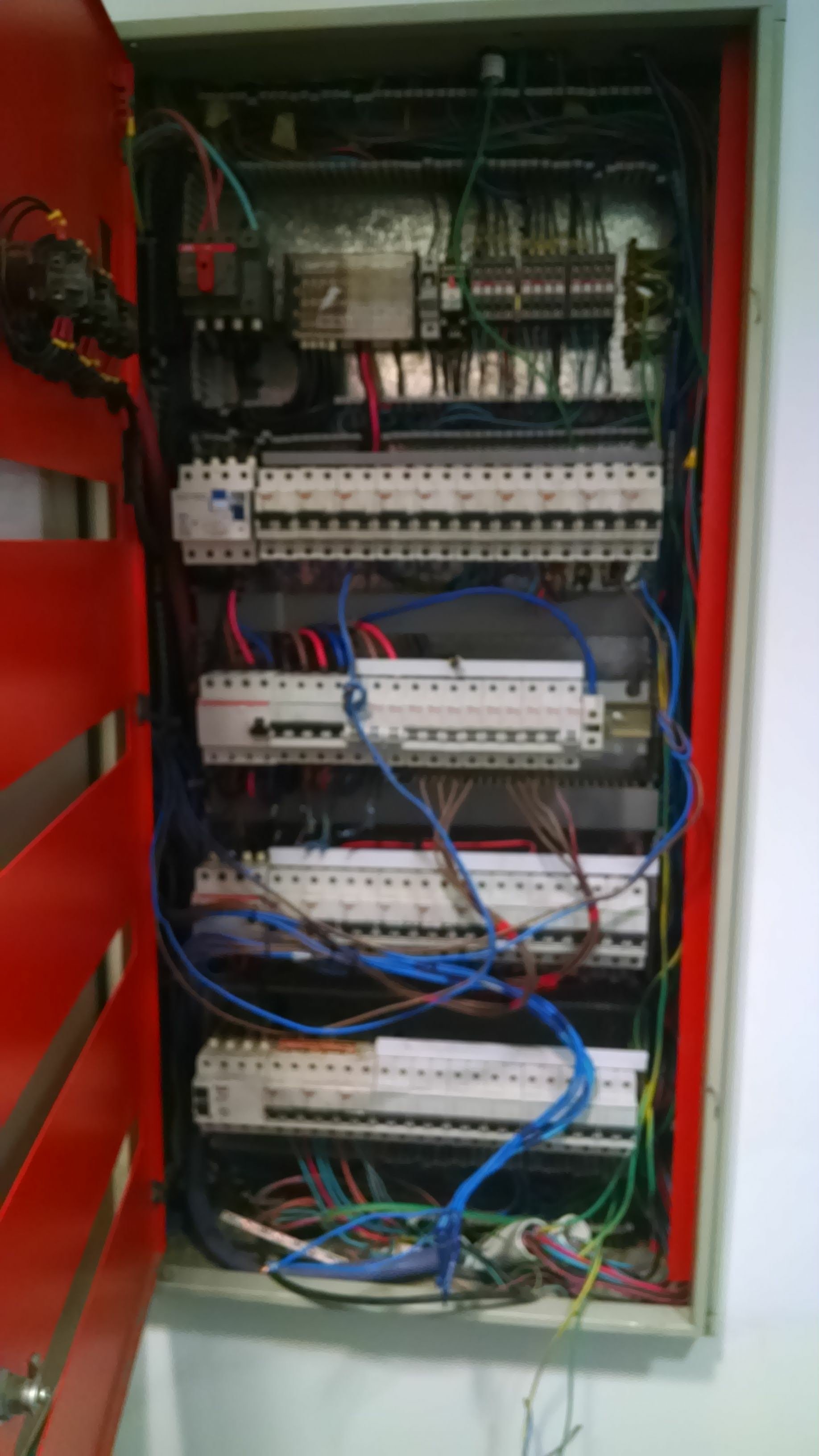Interior de un tablero eléctrico con cables de diferentes colores y componentes electrónicos.