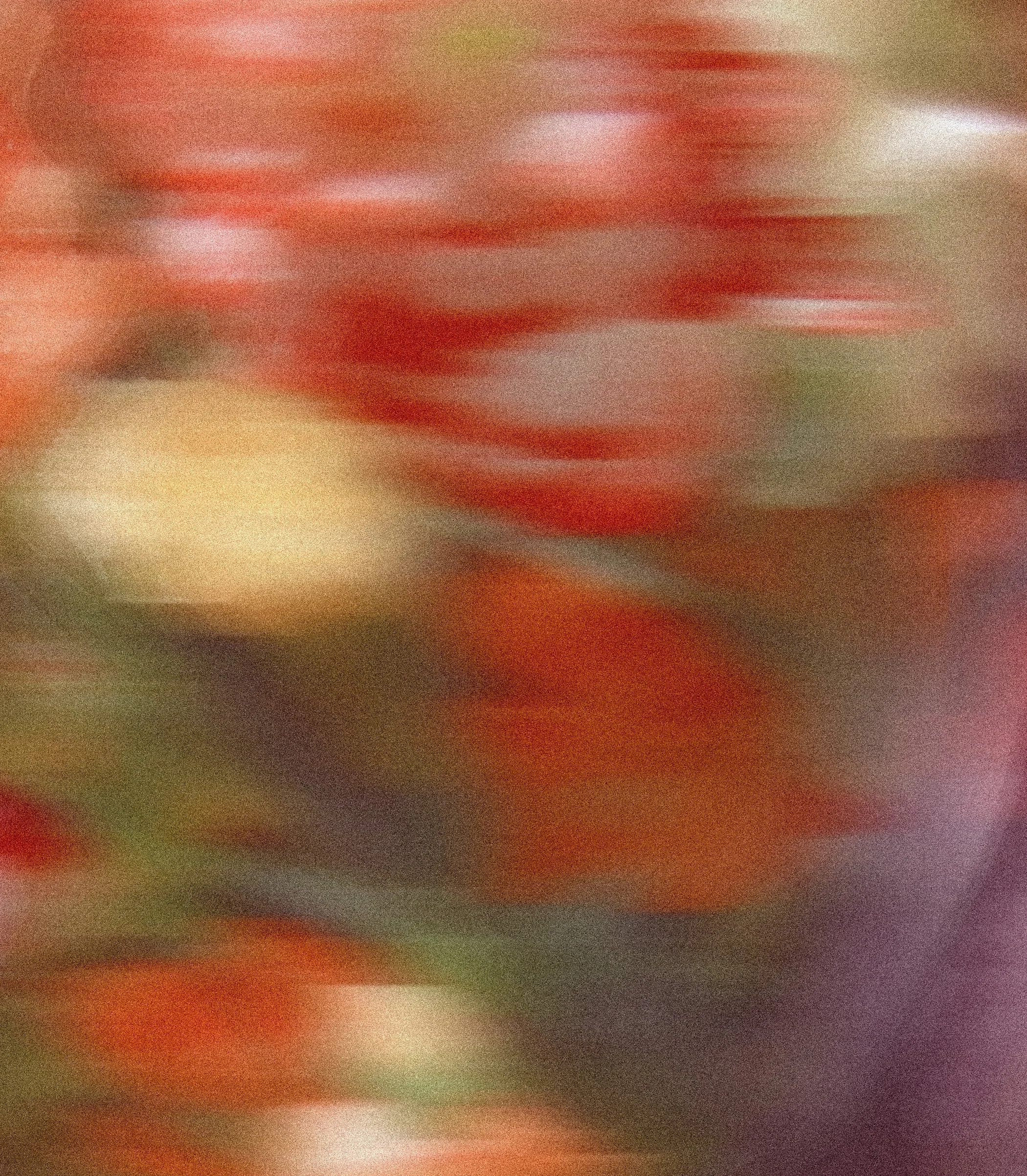 Image floue avec des couleurs rouge, orange, vert et blanc, aucune forme ou objet identifiable.