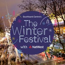Sign for Southbank Centre's Winter Festival featuring NatWest, decorated with colorful stars and holiday lights at dusk.