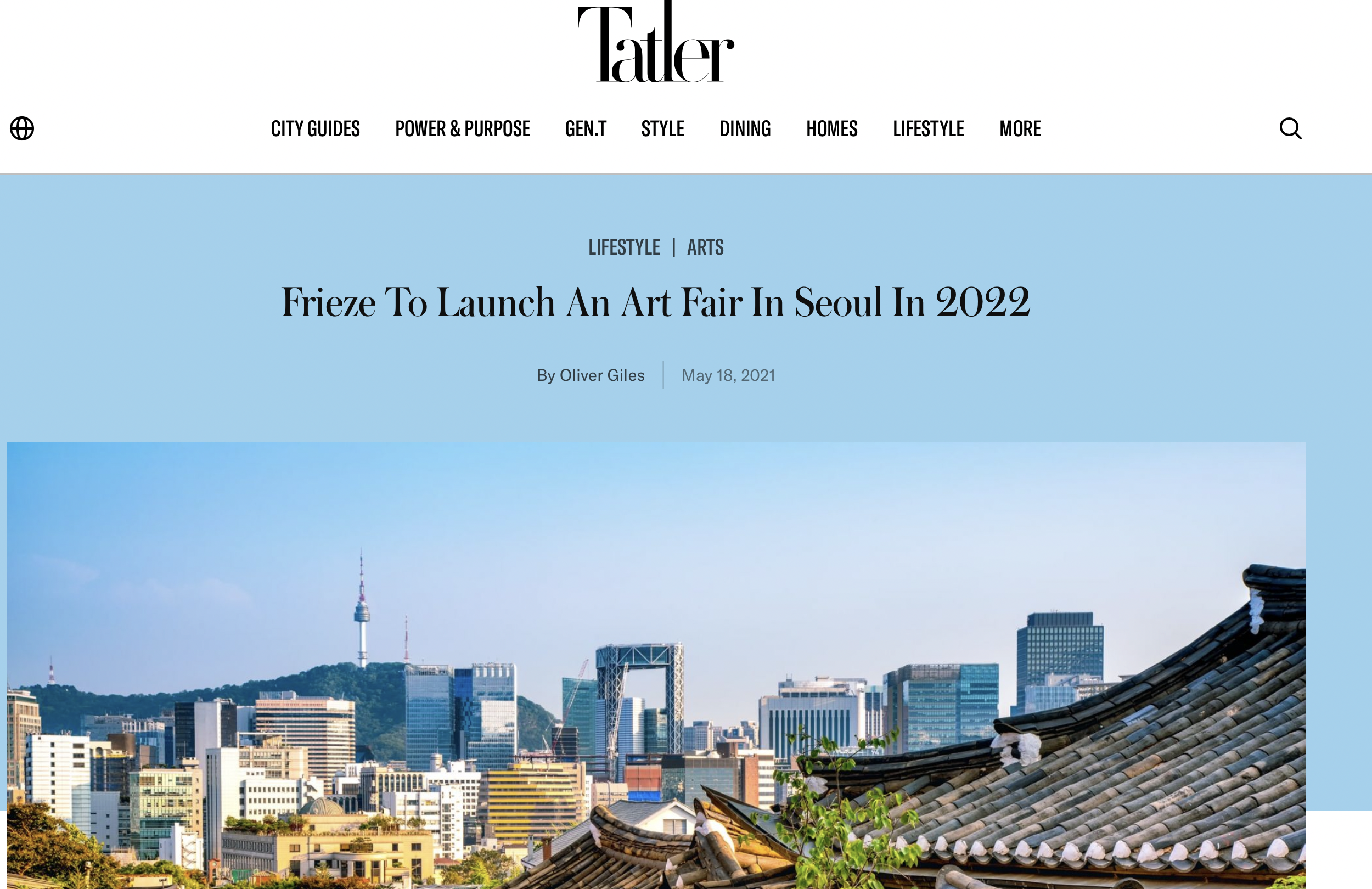 Skyline of Seoul with a mix of modern skyscrapers and traditional rooftops, with Namsan Seoul Tower visible on a hill in the background.