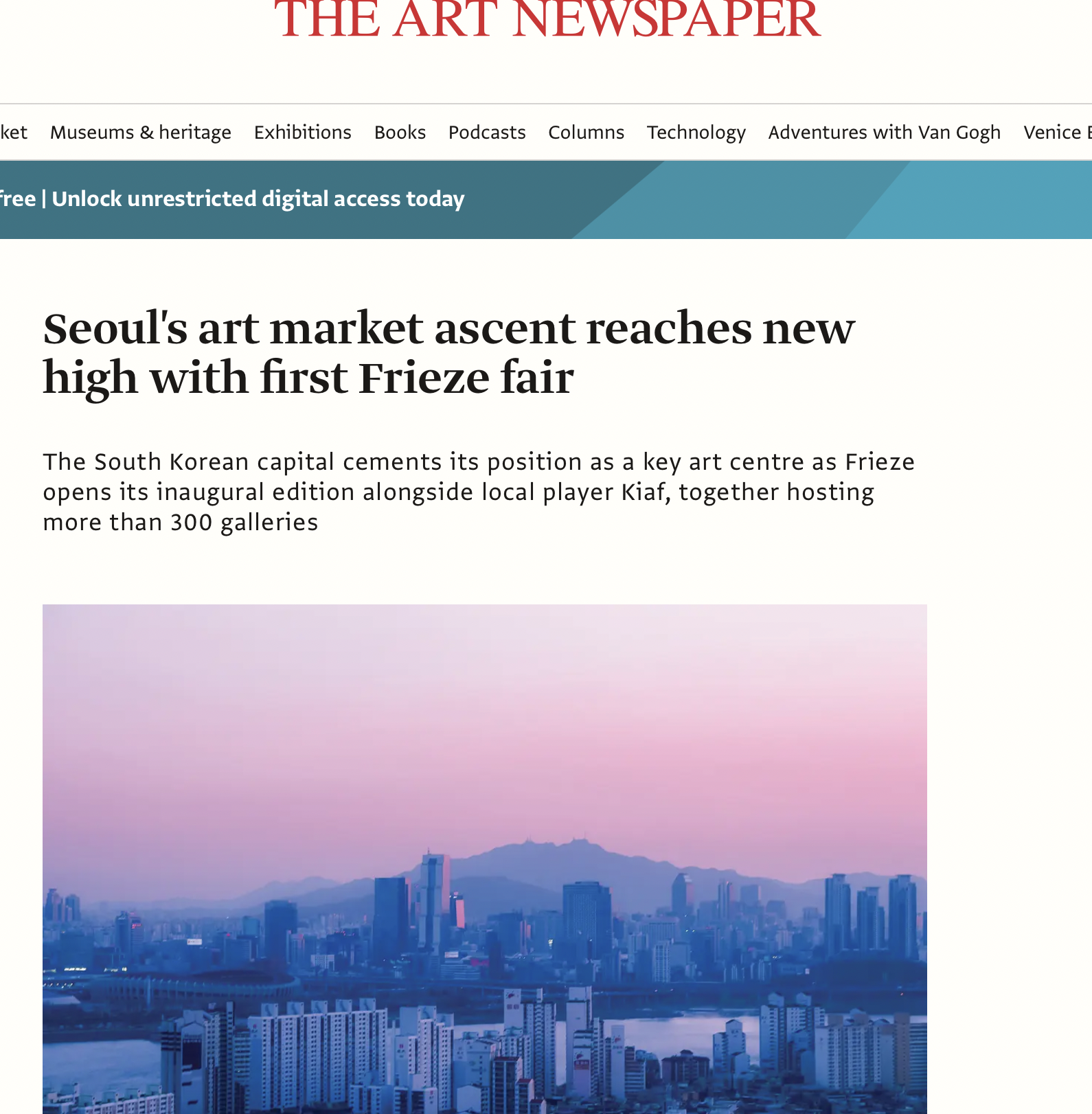 Screenshot of The Art Newspaper website homepage with a headline about Seoul's art market reaching a new high with the first Frieze fair, showing a cityscape with buildings and mountains at sunset or sunrise.