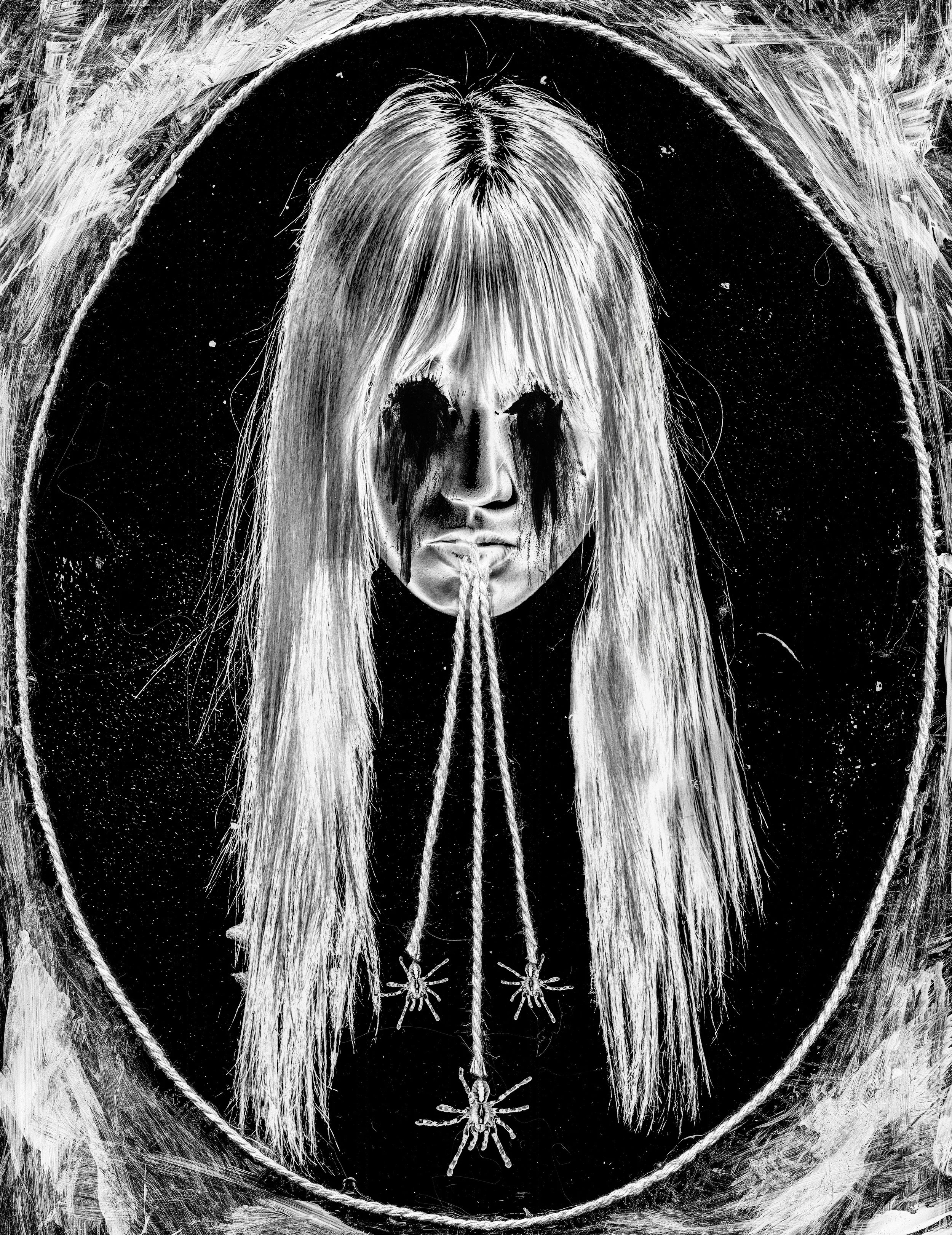 Black and white digital artwork depicting a woman with long hair, makeup resembling a skull, and surrounded by spider and web motifs, creating a dark, gothic aesthetic.
