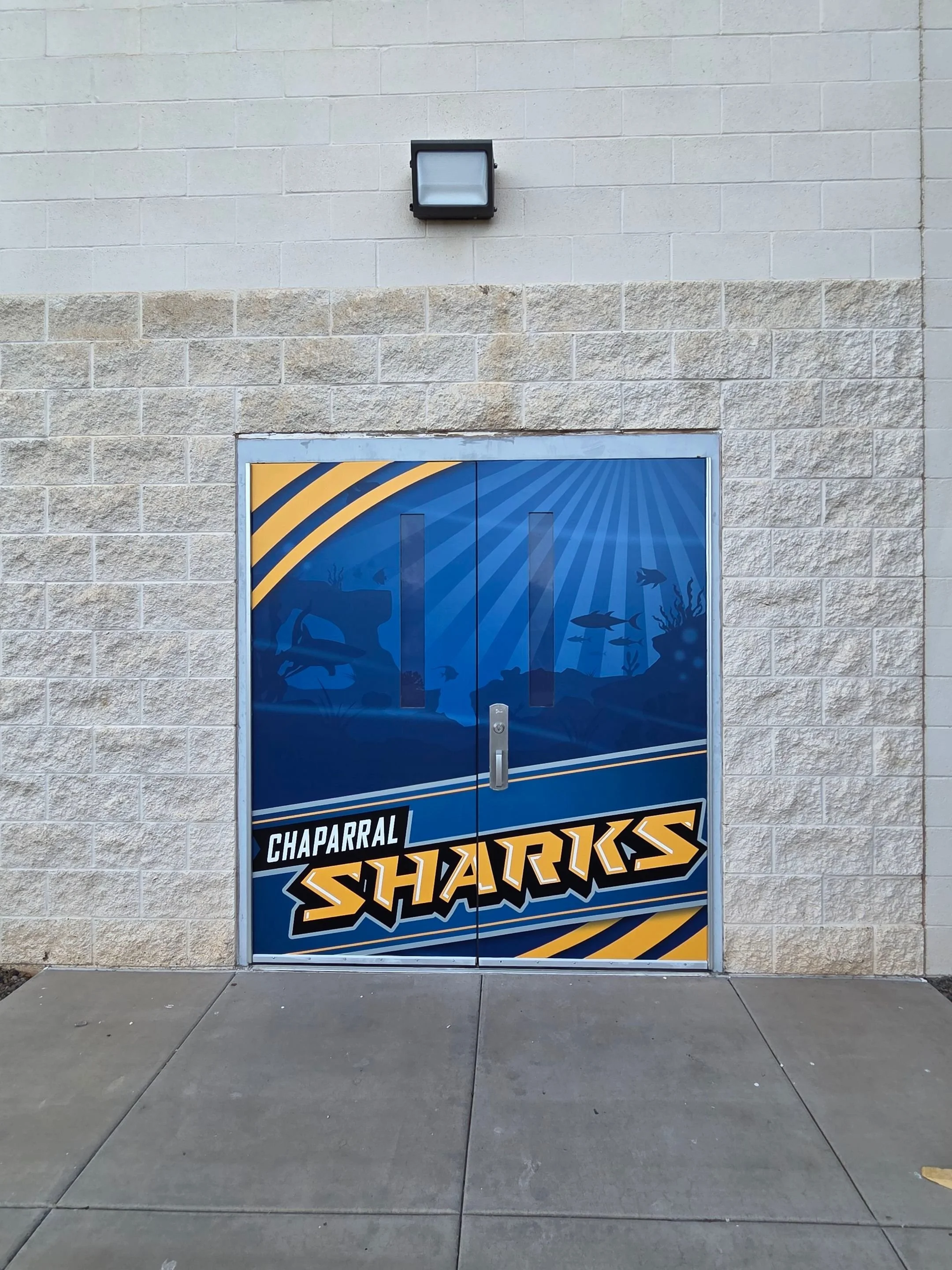A door with a graphic featuring a shark swimming underwater with the words 'Chaparral Sharks'