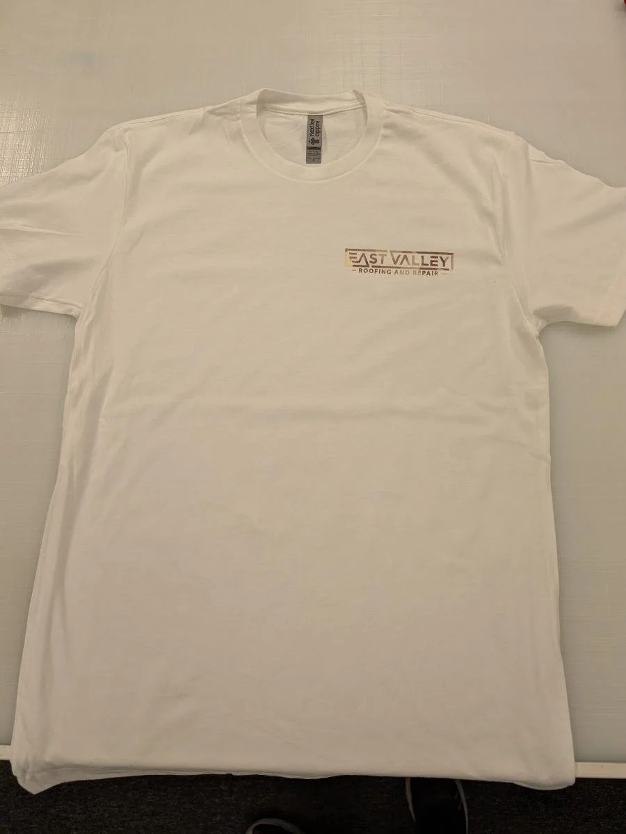 White T-shirt with a logo that reads "East Valley Roofing and Repair" on the front.