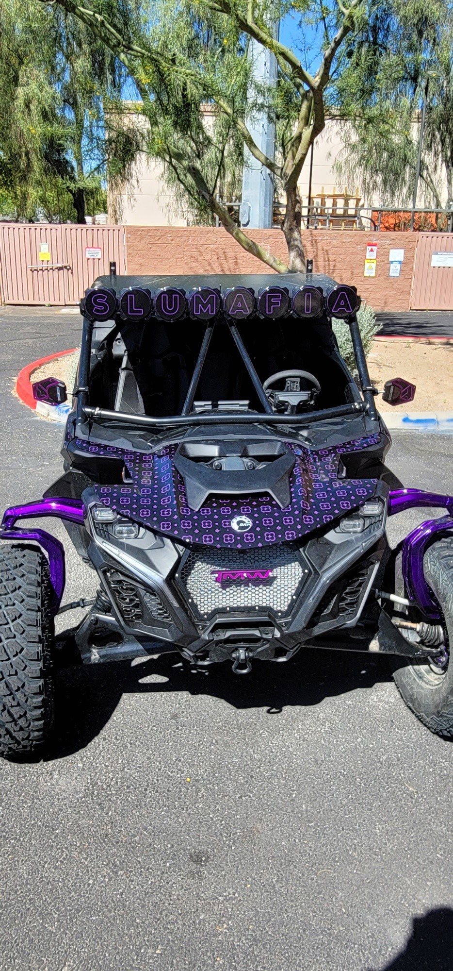 Off-road vehicle with purple accents and a purple banner spelling 'SLUMAFIA' across the top.