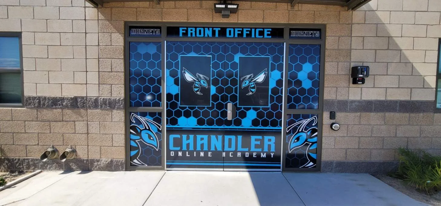 Front entrance of Chandler Online Academy with a sports team theme, featuring logos and blue and black graphics.