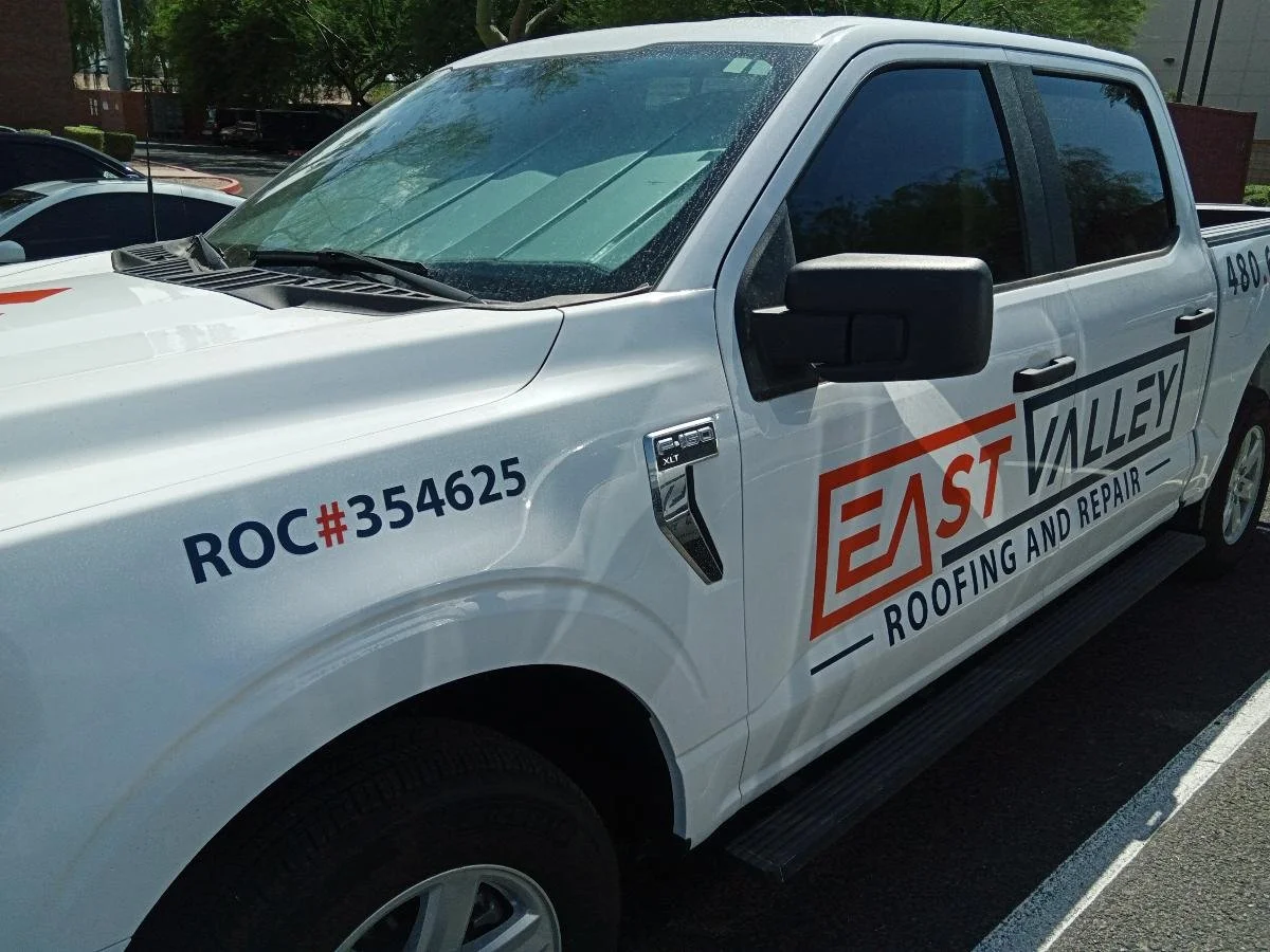 White work truck with the EASE VALLEY Roofing and Repair logo, company contact information, and a license number on the side.