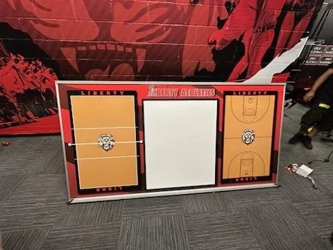Liberty University basketball scoreboard with two court diagrams and a blank space in the middle
