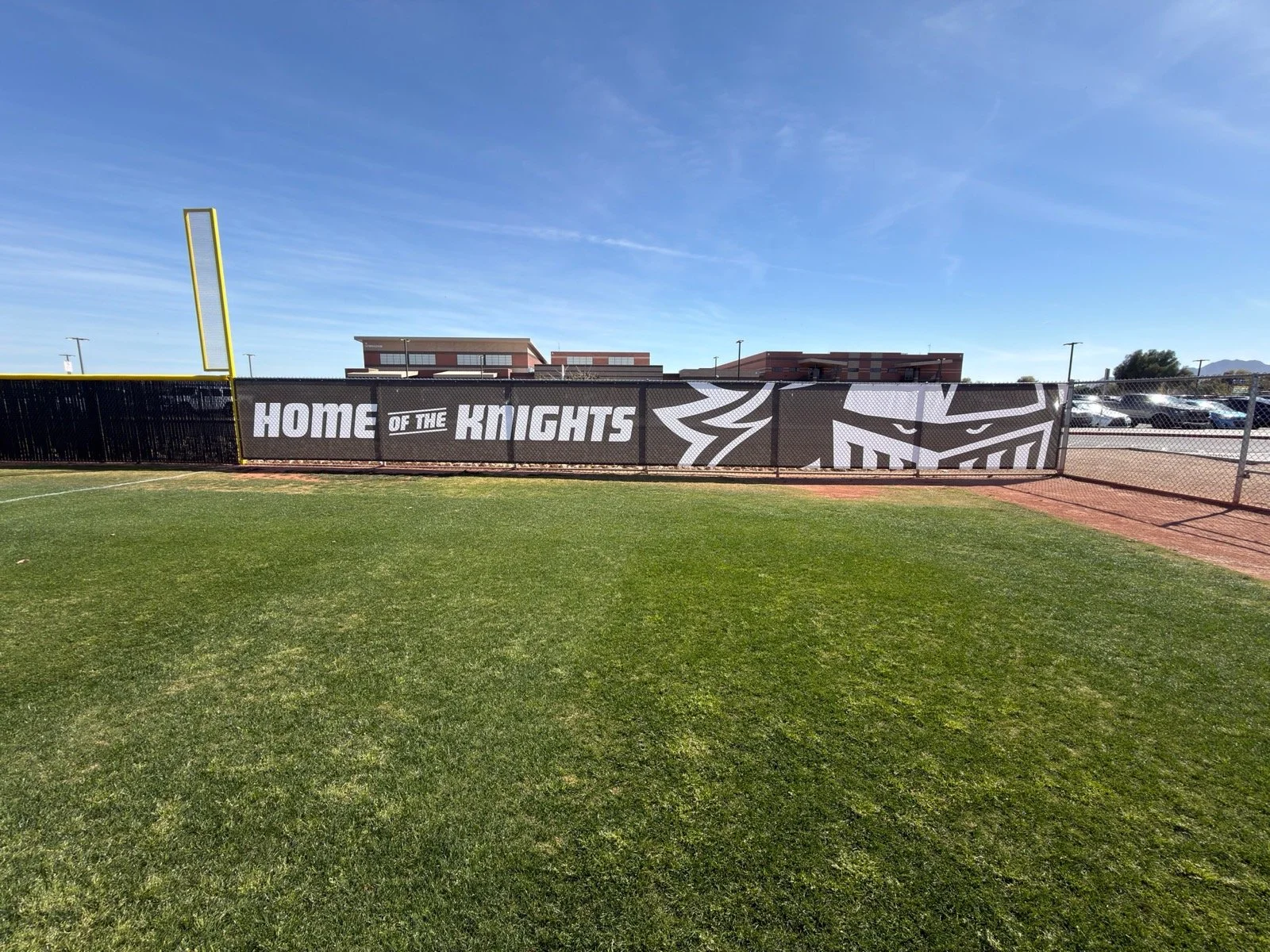 A football field with a black fence featuring 