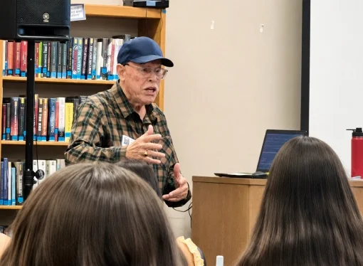 KCSL mentor speaking with high school students during a student leadership gathering.