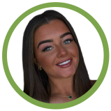 A smiling woman with long dark hair and blue eyes, wearing makeup, against a white background with a green circular border.