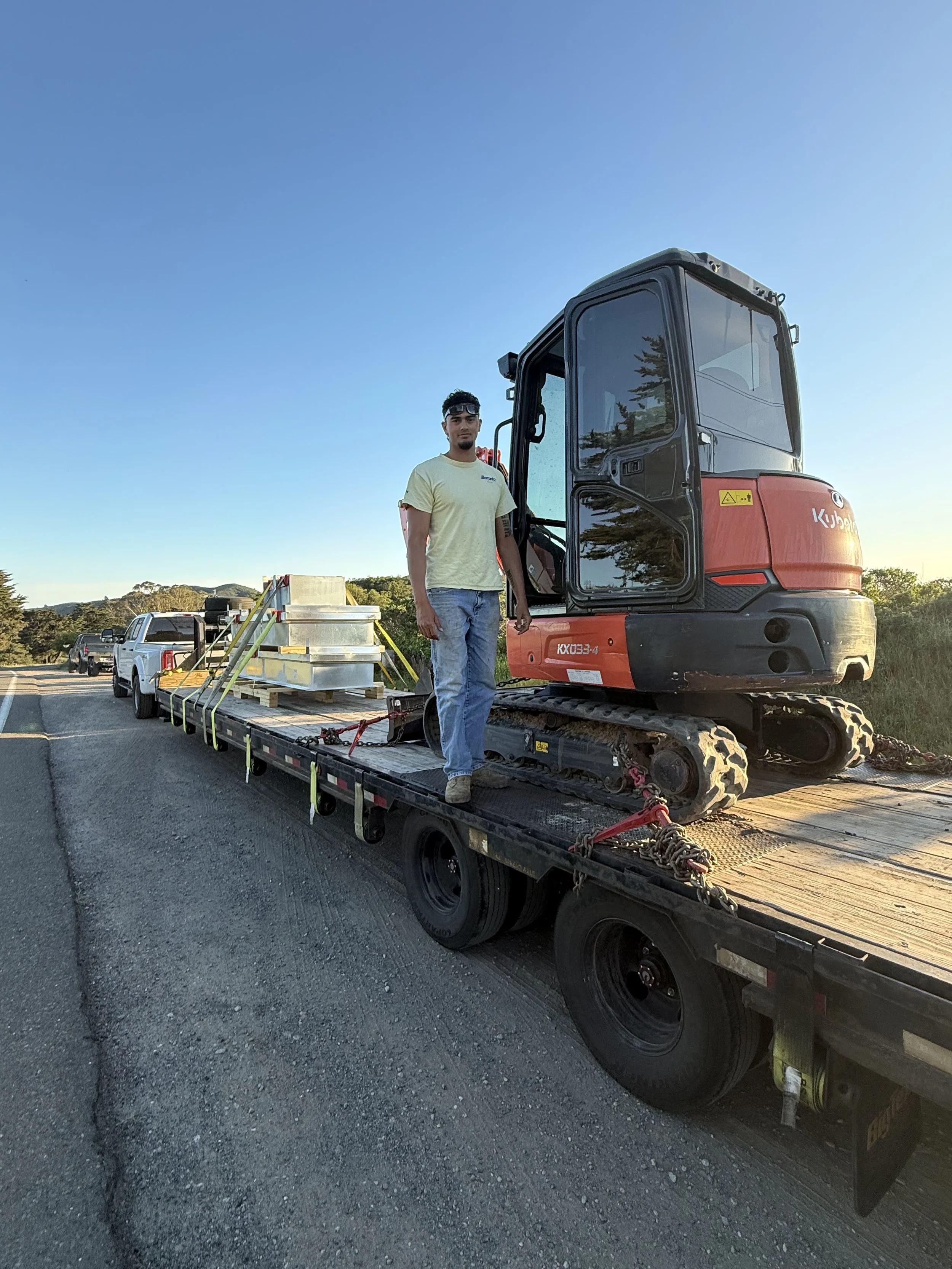 Kubota mini excavator loaded on an equipment trailer.