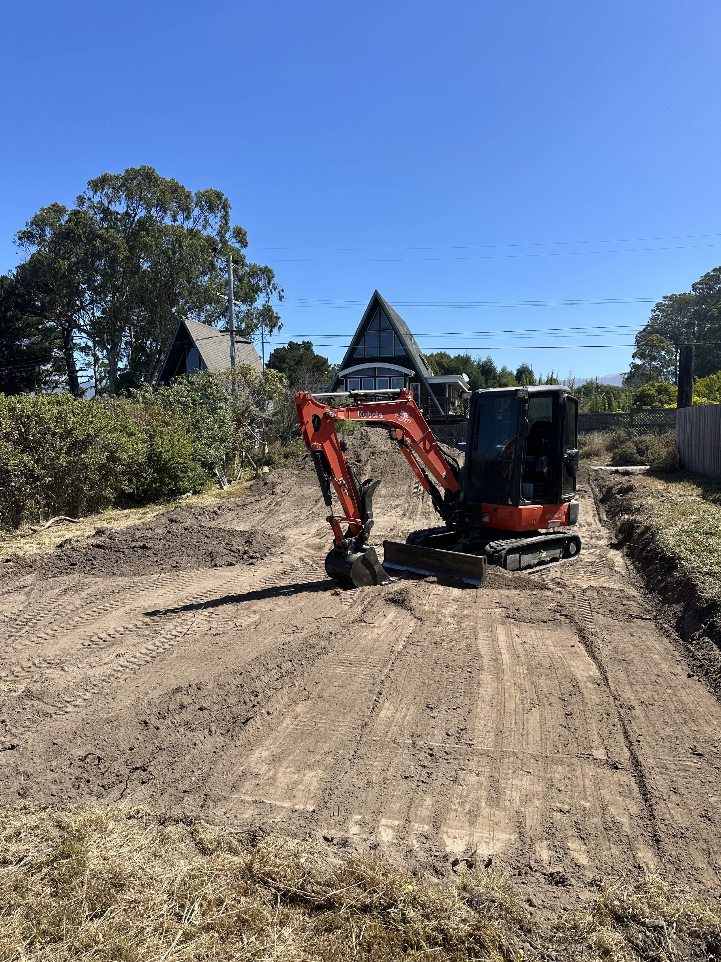 Mini excavator performing site preparation and grading work in the North Bay.