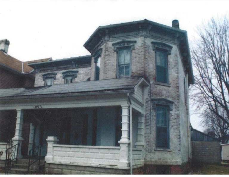 Original Good Samaritan Home brick house with a front porch, tall windows, and a bay window on the second floor in Ohio.