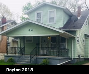 A light green two-story house with black railings on the front porch, located in Dayton in 2018 depicting Good Samaritan Home's housing expansion for those looking for re-entry. 