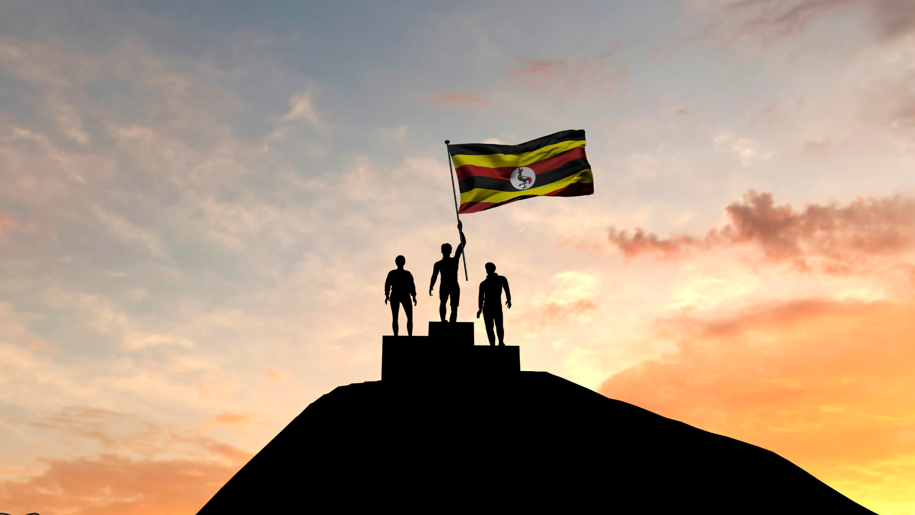 Silhouettes of three people standing on a podium at sunset, with the person in the middle holding a Ugandan flag