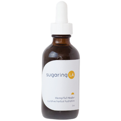 A small brown glass dropper bottle labeled 'sugaring LA,' containing hemp herbal hydration.