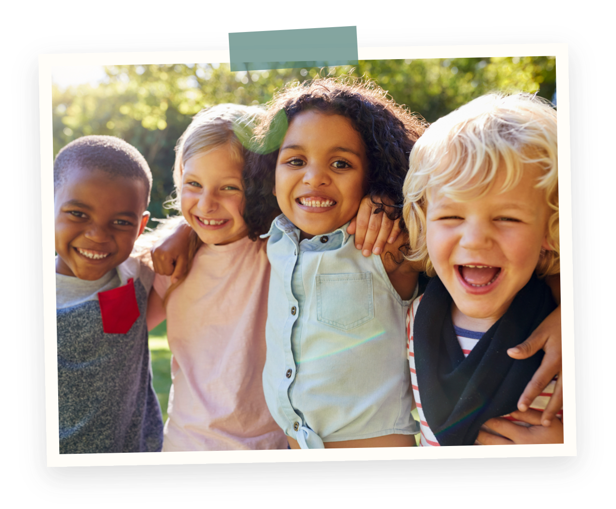 Marpole Kerrisdale preschool kids program having fun. Four children smiling and embracing outdoors on a sunny day.