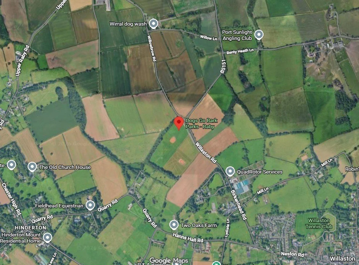 Satellite map showing rural area with roads, fields, and points of interest such as Dogs Go Bark Parks - Raby, Wirral dog wash, Port Sunlight Angling Club, and other local landmarks.