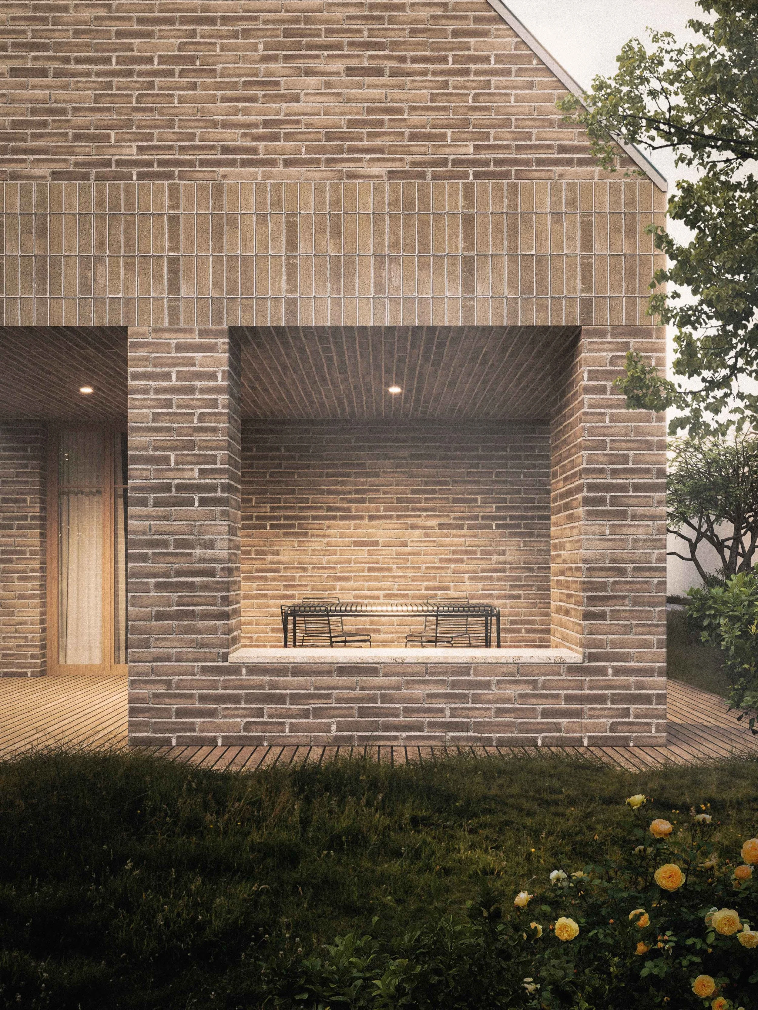 Exterior view of a modern brick house with a covered patio area, a metal table, and surrounding greenery and flowering plants.